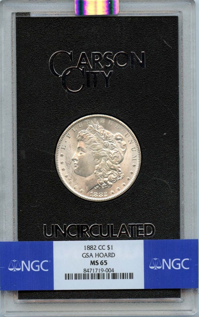 1882-CC Morgan Dollar GSA HOARD S$1 NGC MS65: 1882-CC Morgan Dollar GSA HOARD S$1 NGC MS65 1882-CC Morgan Dollar GSA HOARD MS65, certified by the Numismatic Guaranty Corporation (NGC) with a grade of MS65, showcases exceptional preservation and d