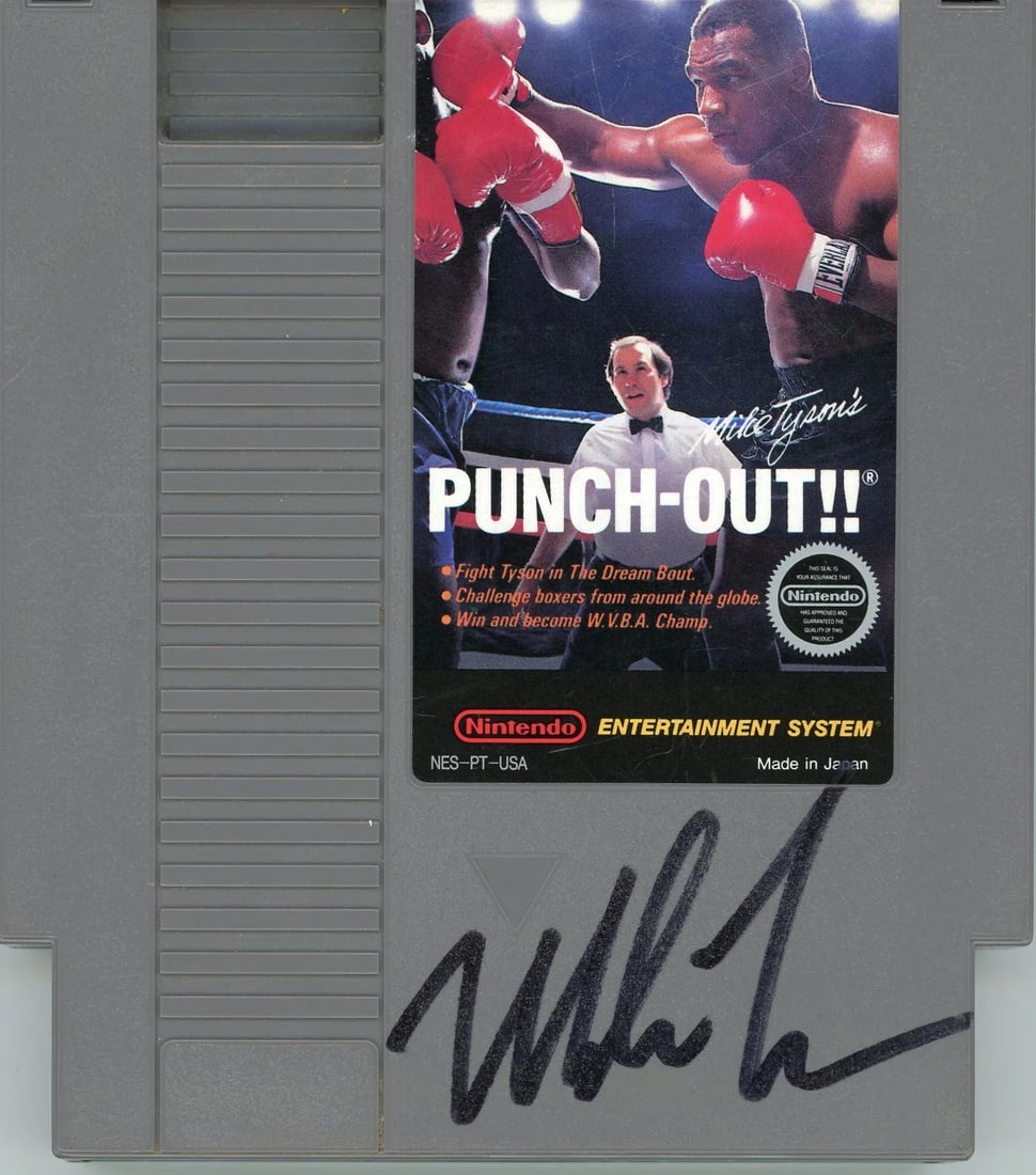 Mike Tyson Autographed Authentic NES Game (JSA): Mike Tyson Autographed Authentic NES Game (JSA) Authentic NES game featuring a bold black signature from Mike Tyson, verified by James Spence Authentication. The game's condition may vary, but its uni