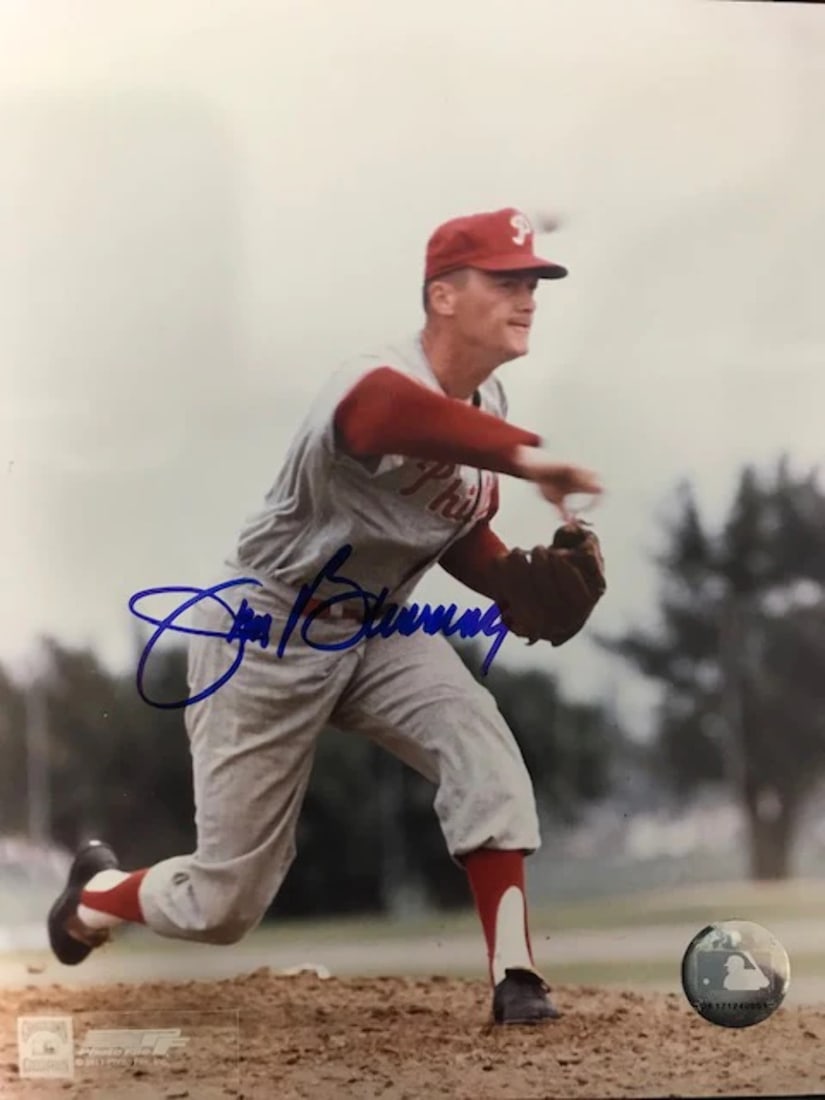 Jim Bunning Autographed 8x10 Baseball Photo: Jim Bunning Autographed 8x10 Baseball Photo Signed across the front in blue sharpie, this 8x10 baseball photo showcases Jim Bunning's signature. The item is presented as-is, with no additional informa