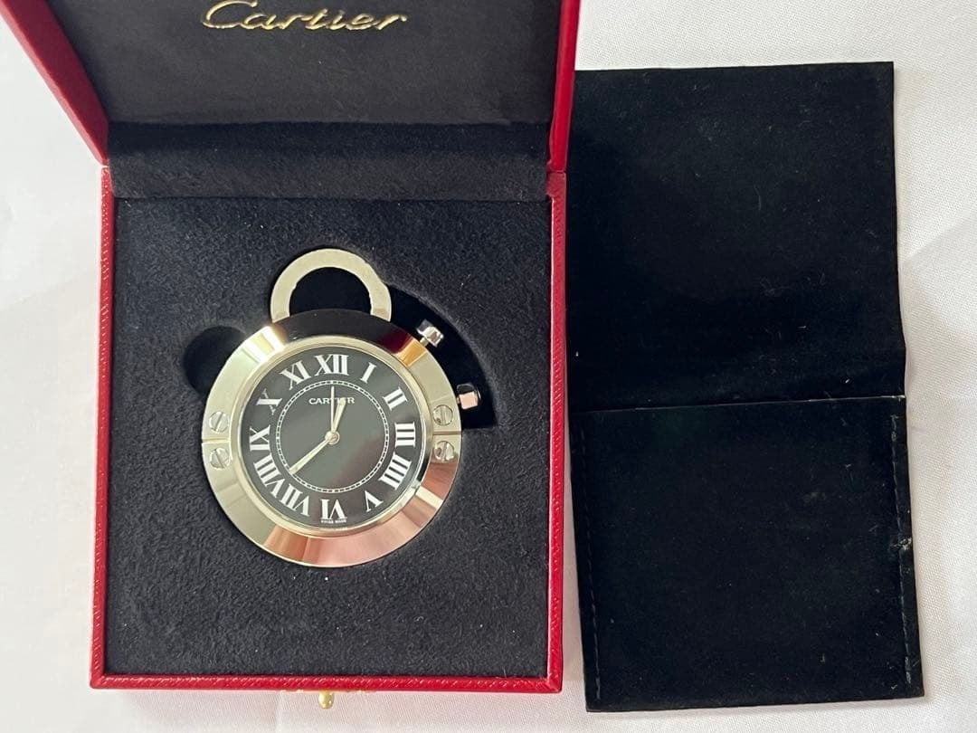 Cartier Table Clock Travel Alarm Black Roman Dial Quartz Case Papers Booklet: Cartier Table Clock Travel Alarm Black Roman Dial Quartz Case Papers Booklet Item Specifics: Antique: No Shape: Round Power Source: Battery Vintage: No Display Type: Analog Style: Luxury Frame Materia