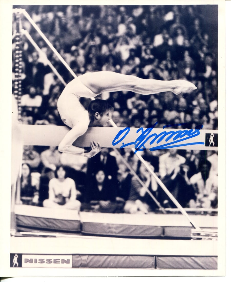 Korbut Olga Autographed Photo 8x10: Korbut Olga Autographed Photo 8x10 Olga Korbut's iconic pose from her abeam routine is captured in this 8x10 photo, signed by the legendary gymnast herself. The sharpie signature adds a personal touch