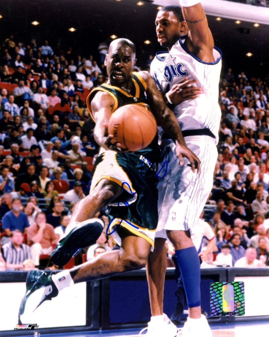 Gary Payton Autographed Basketball 8x10 Photo: Gary Payton Autographed Basketball 8x10 Photo Signed in blue sharpie across the front, Gary Payton's autograph adds a touch of authenticity to this 8x10 photo. The basketball itself is a great piece f