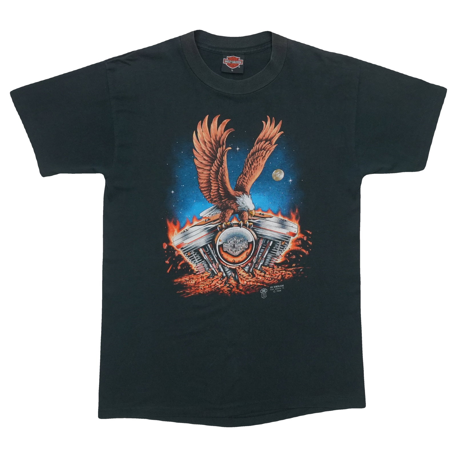 Harley Davidson 3D Emblem Shirt: Harley Davidson 3D Emblem Shirt A true vintage find, this 1989 Harley Davidson 3D emblem shirt boasts front and back graphics and measures 18" pit to pit with a collar to hem length of 28.5 inches. Ma