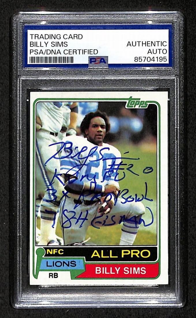 1981 TOPPS RC Billy Sims Signed/ Inscribed Card #100 Lions PSA/ DNA 203877: 1981 TOPPS RC Billy Sims Signed/ Inscribed Card #100 Lions PSA/ DNA 203877 Signed by Billy Sims, the legendary running back for the Detroit Lions in the 1980s, this 1981 Topps RC card features a uniqu