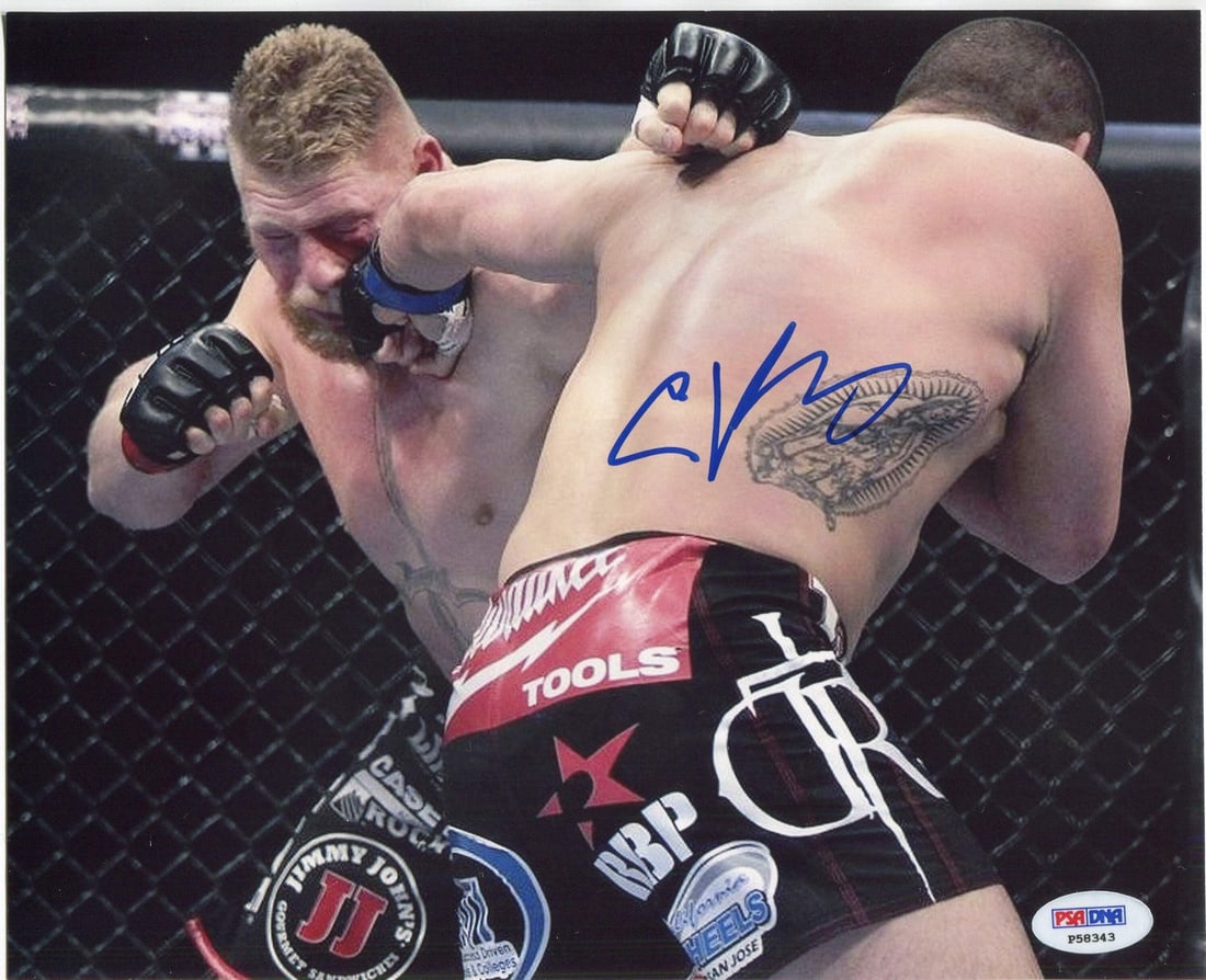 Cain Velasquez Autographed 8x10 Photo PSA/ DNA: Cain Velasquez Autographed 8x10 Photo PSA/ DNA Cain Velasquez's bold signature in blue sharpie adds a touch of authenticity to this official 8x10 photo, capturing the intensity of his UFC career. Grad