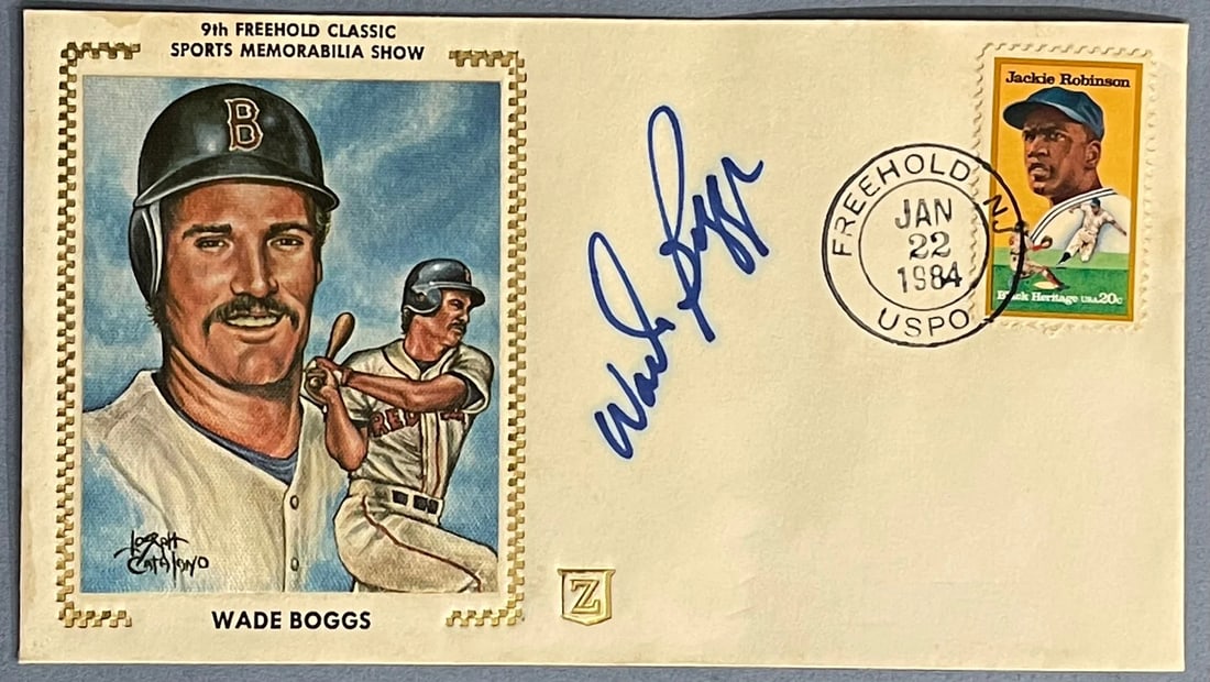 Wade Boggs Autographed First Day Cover: Wade Boggs Autographed First Day Cover Wade Boggs Autographed First Day Cover bears the signature in blue sharpie across the front, a notable feature of this collectible item. The first day cover itse