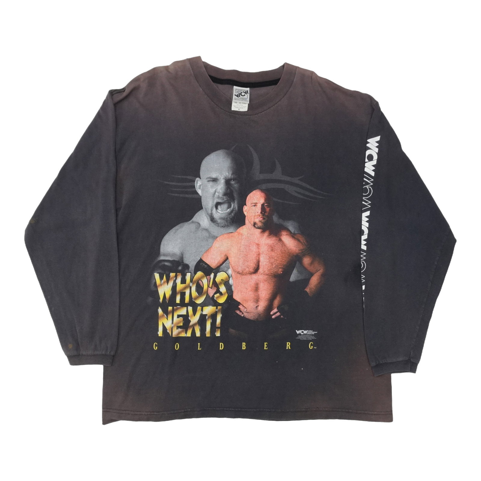 1998 WCW Goldberg Whos Next Long Sleeve Shirt: 1998 WCW Goldberg Whos Next Long Sleeve Shirt Extra Large WCW Goldberg Whos Next Long Sleeve Shirt. This vintage 1998 shirt features heavy fading across the shoulders and light cracking on the graphic