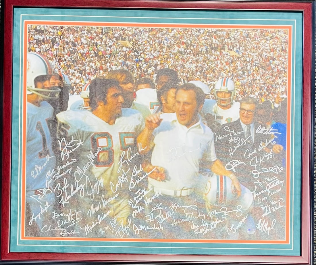 Dolphins Autographed Framed 1972 Canvas: Dolphins Autographed Framed 1972 Canvas Signed by 24 members of the 1972 Miami Dolphins team, including Bob Griese and Jim Kiick, this autographed framed canvas offers a unique piece of sports history