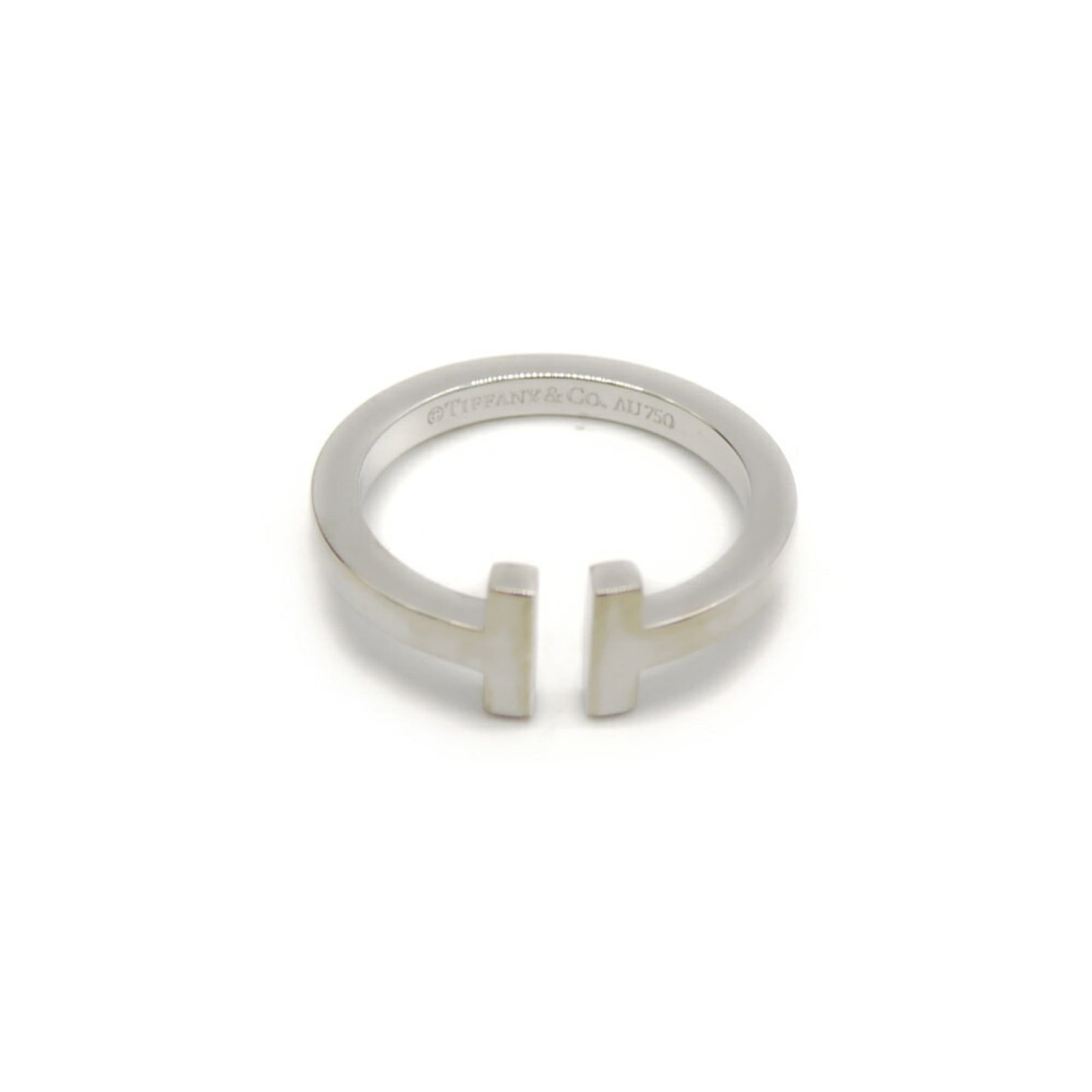 Ring of Tiffany: Ring of Tiffany 18K white gold band ring with a notable signature. Weighing in at 7.9g, this piece boasts a metal purity of 18K and features a US size of 10.5. The ring's weight and metal purity are