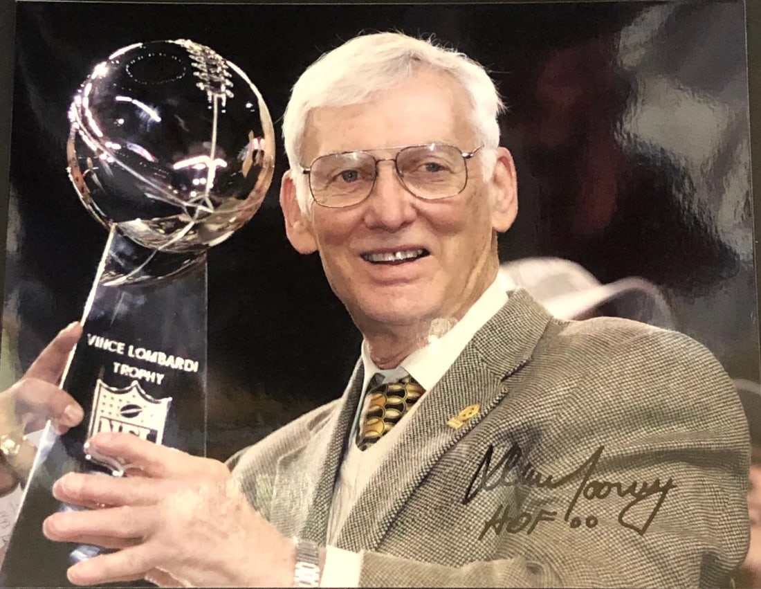 Rooney Dan Autographed Photo Football 8x10: Rooney Dan Autographed Photo Football 8x10 Dan Rooney's silver sharpie signature reads "HOF 00" across the front of this official 8x10 football photo. The item bears a notable autograph, making it a