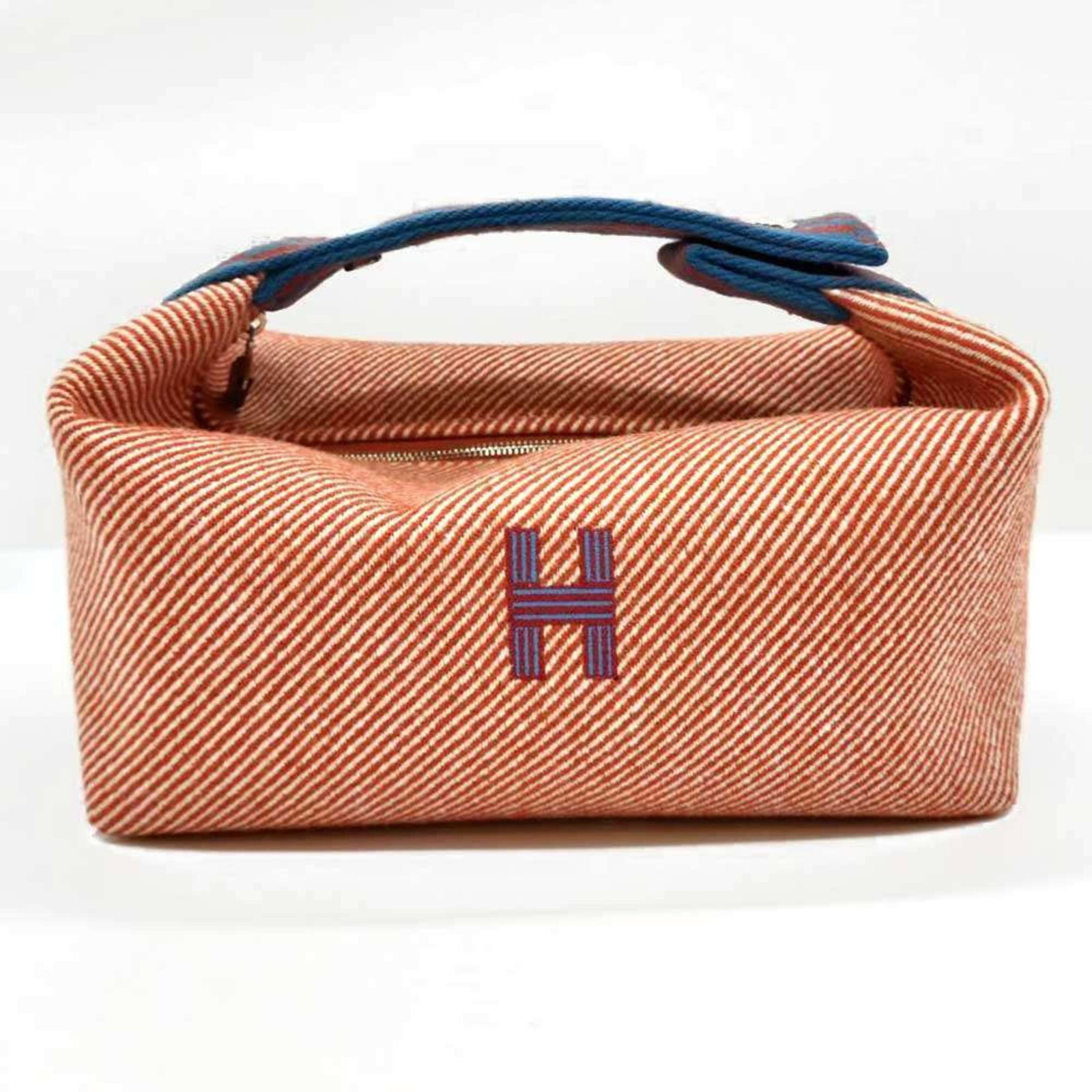 Hermes Handbag Pouch Canvas: Hermes Handbag Pouch Canvas Canvas pouch from the iconic French brand Hermes, featuring a vibrant blue, orange, and red color scheme. Measuring 10cm x 21cm x 12cm, this stylish accessory comes in a st