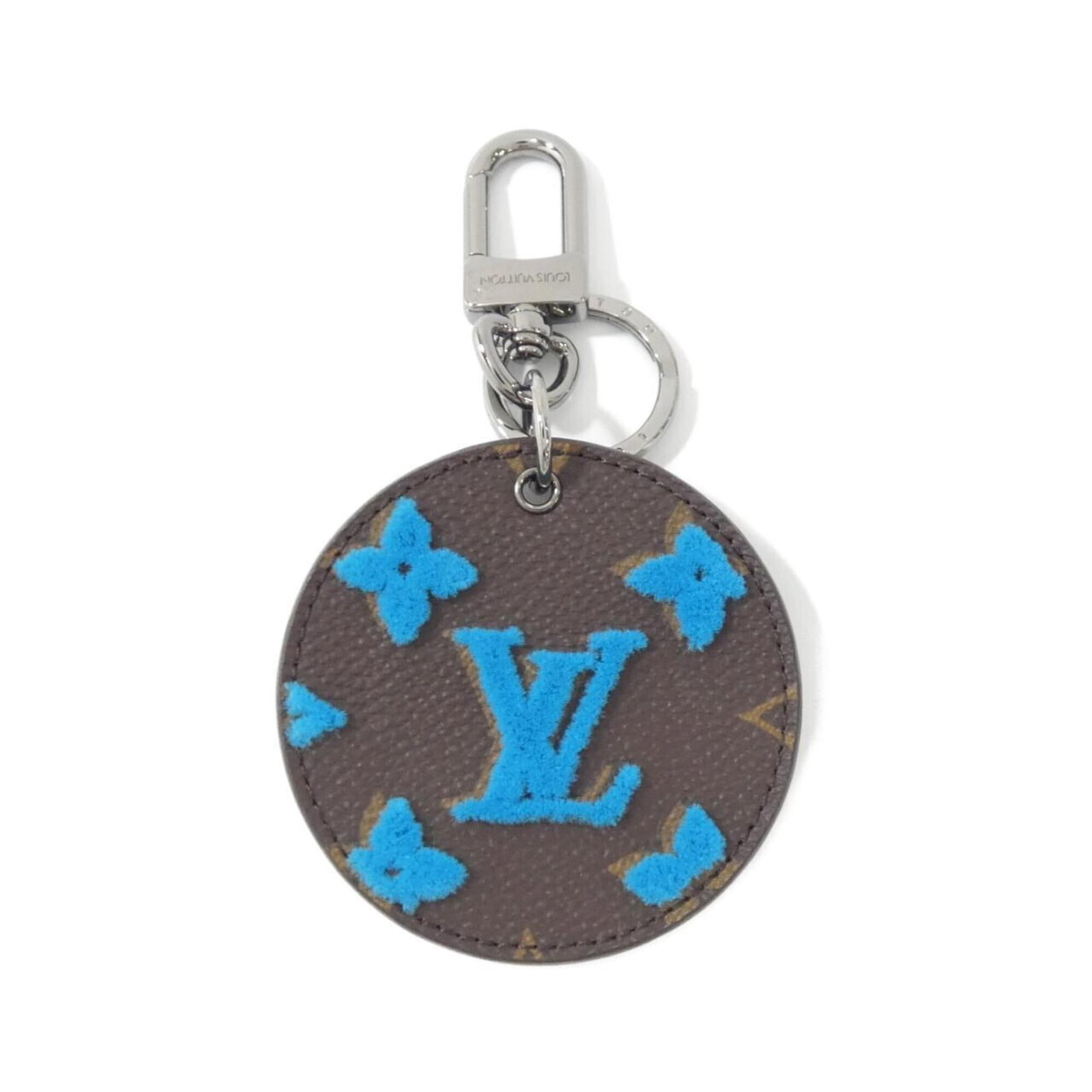 Louis Vuitton Keyring: Louis Vuitton Keyring Blue Louis Vuitton Keyring. This keyring bears the iconic blue color and is made by the renowned luxury brand, Louis Vuitton. A simple yet elegant accessory that adds a touch of