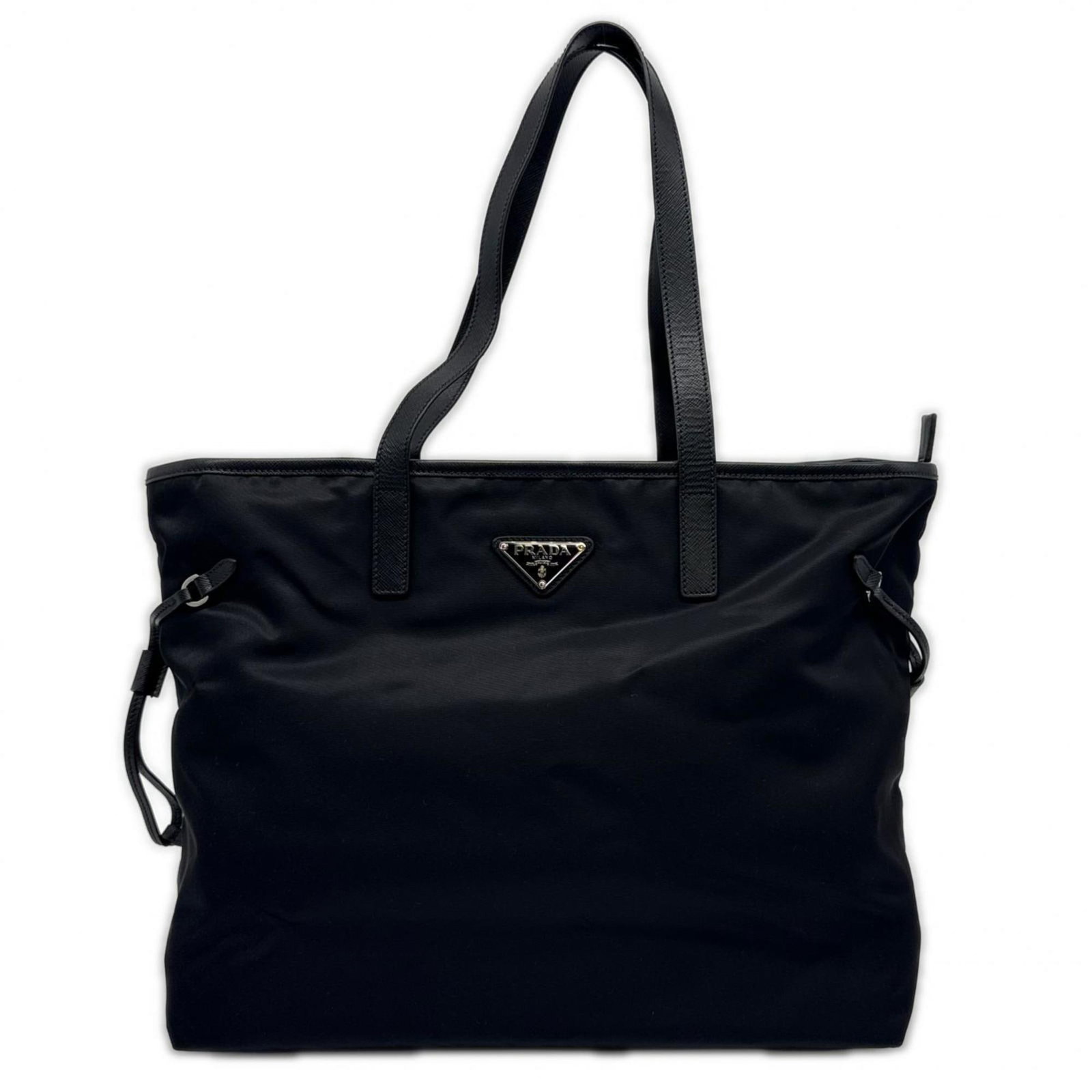 Nylon leather Prada tote bag: Nylon leather Prada tote bag Nylon leather Prada tote bag in black, measuring 28cm x 42cm x 24cm. This stylish and functional bag features a unique blend of nylon and leather materials, combining
