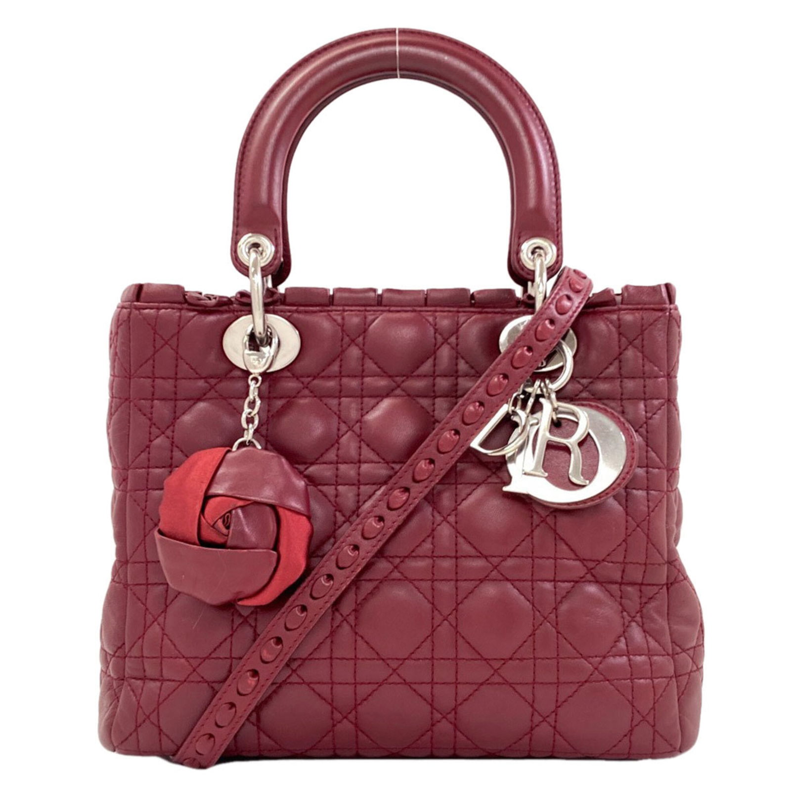 Handbag Christian Dior Leather: Handbag Christian Dior Leather The Lady Dior handbag by Christian Dior features a striking red color and high-quality calfskin leather construction. With its sleek design, zipper closure, and
