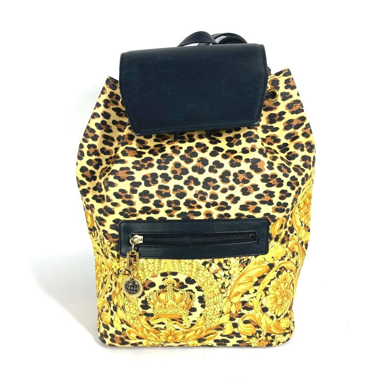 PVC Leather Versace Backpack: PVC Leather Versace Backpack PVC and leather combine in this sleek Versace backpack, available in black with yellow accents. The compact design measures 34.5cm x 25.5cm x 13.5cm, making it a practical