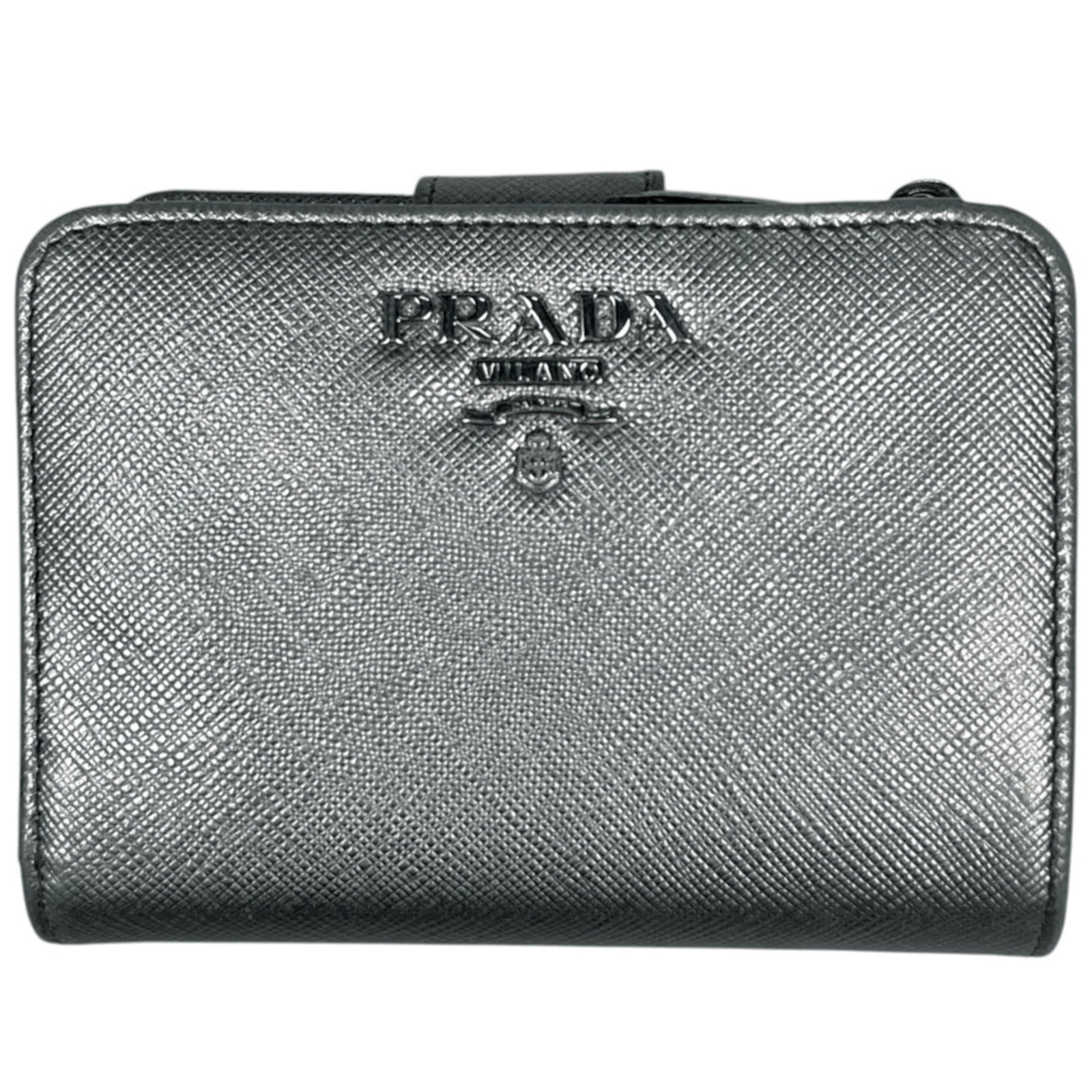 Saffiano Wallet Bi Fold By Prada: Saffiano Wallet Bi Fold By Prada Prada's Saffiano Wallet Bi Fold boasts sleek, sophisticated design with a silver finish. Crafted from durable Saffiano material, this bi-fold wallet measures 9cm x 12c