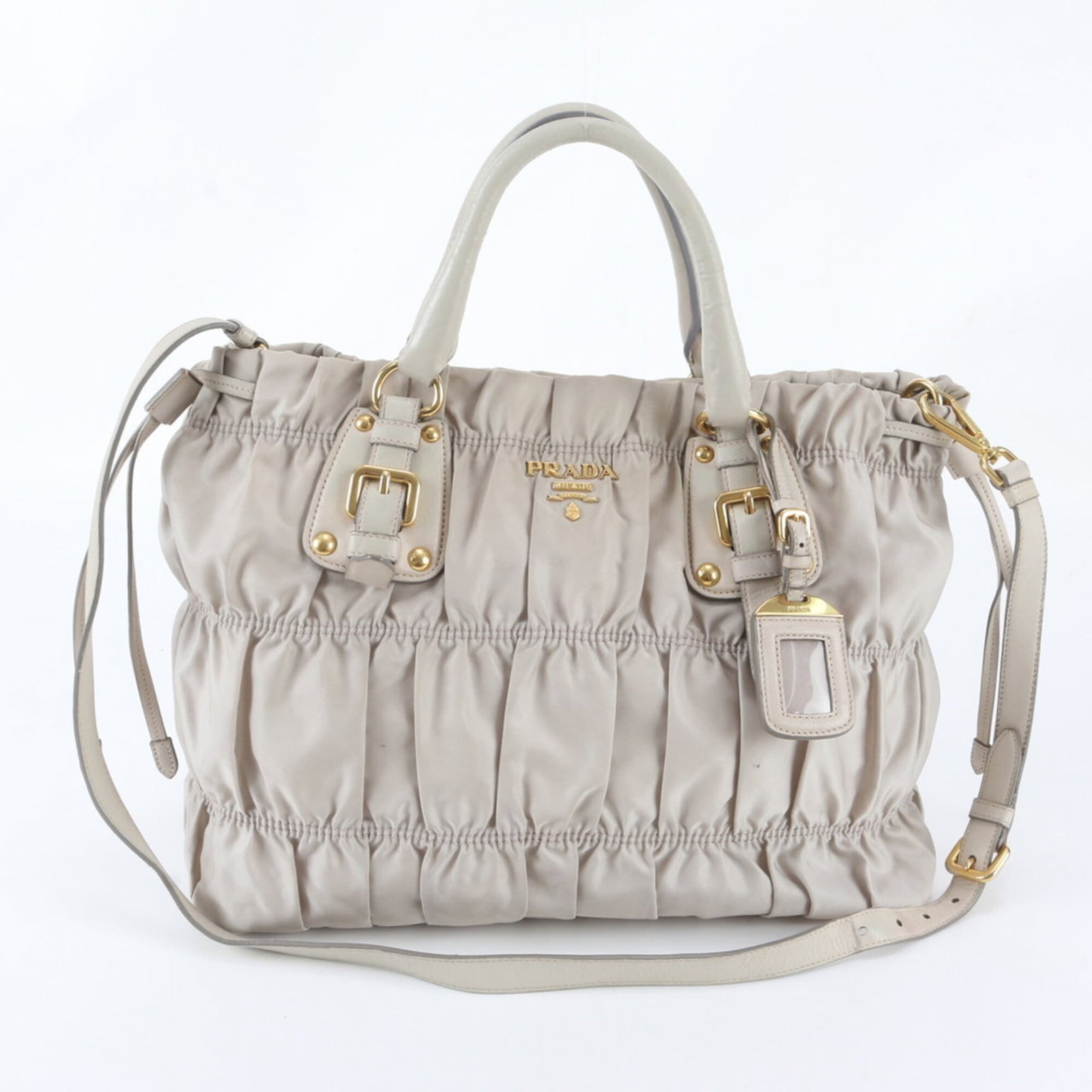 Nylon Leather Prada Tote Bag: Nylon Leather Prada Tote Bag Nylon and leather blend in this elegant Prada tote bag, available in ivory. Measuring 30cm x 35cm x 15cm, it features a classic shoulder design with a timeless aesthetic. 