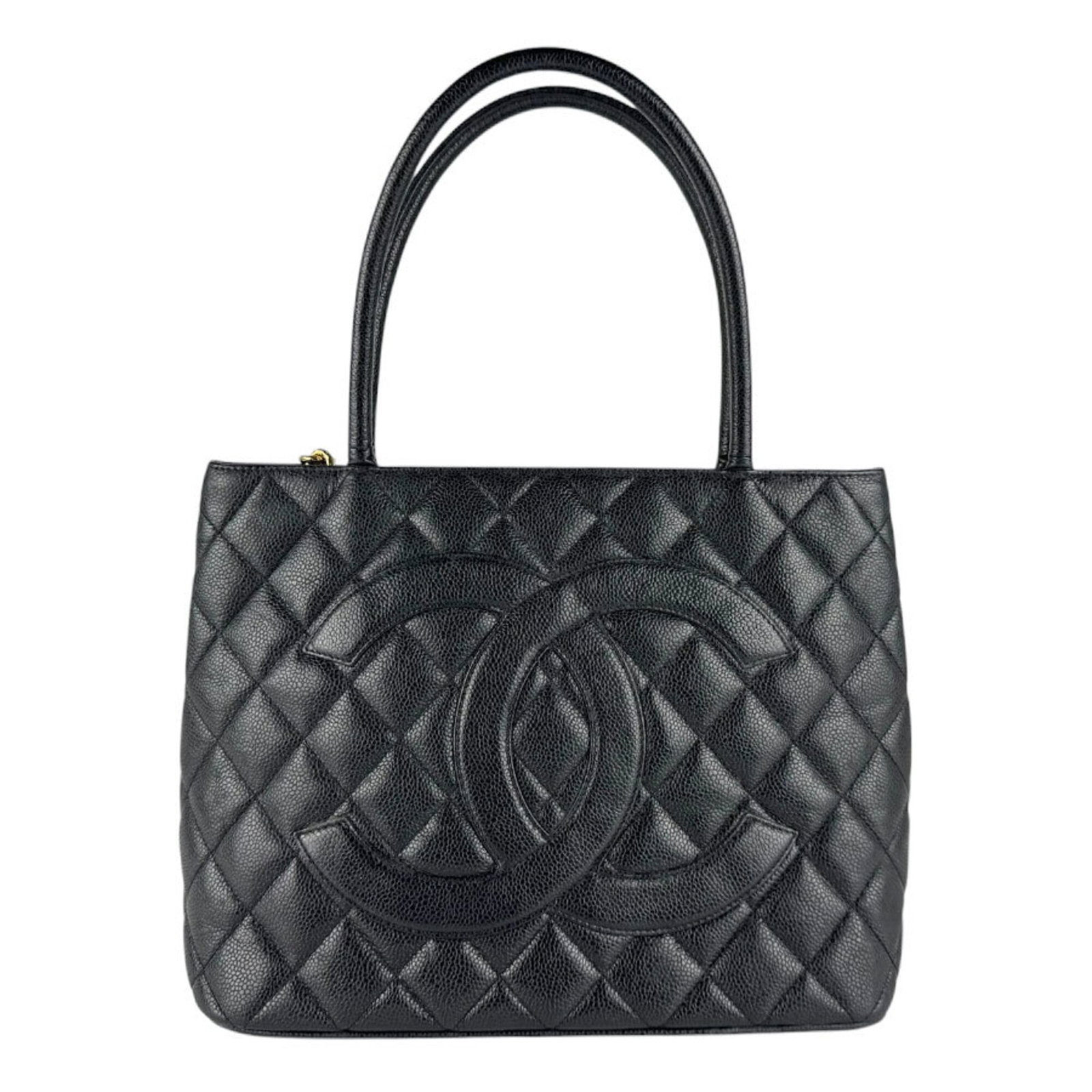 Calfskin Handbag by Chanel: Calfskin Handbag by Chanel Calfskin Handbag by Chanel features a sleek black design made from high-quality grained calfskin. The bag's classic style and timeless appeal make it a stylish accessory for