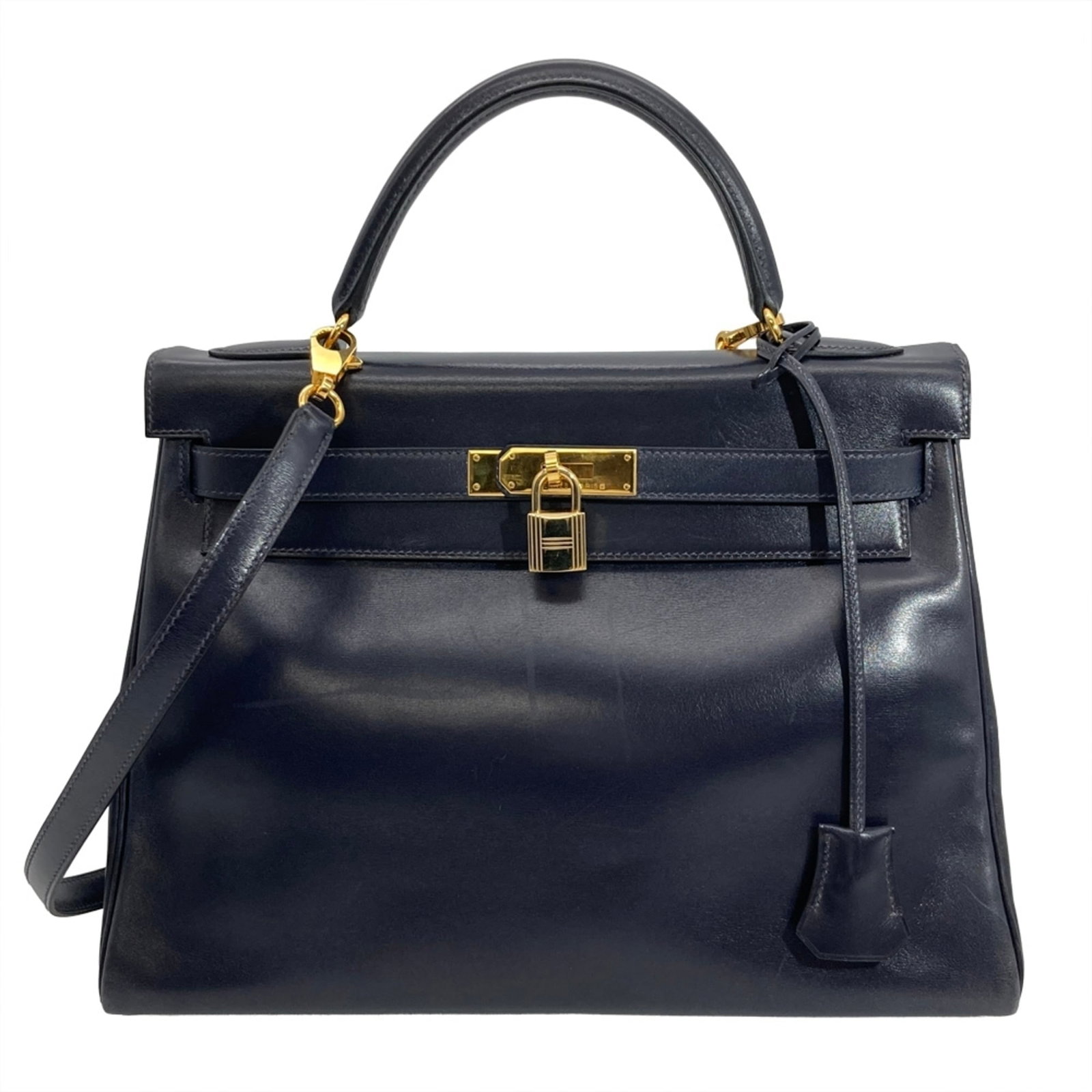 Calf Leather Handbag Hermes Box: Calf Leather Handbag Hermes Box Box calf leather construction provides a durable and long-lasting finish for the navy-colored handbag. Measuring 23cm x 31.5cm x 12cm, this Hermes-style bag features a