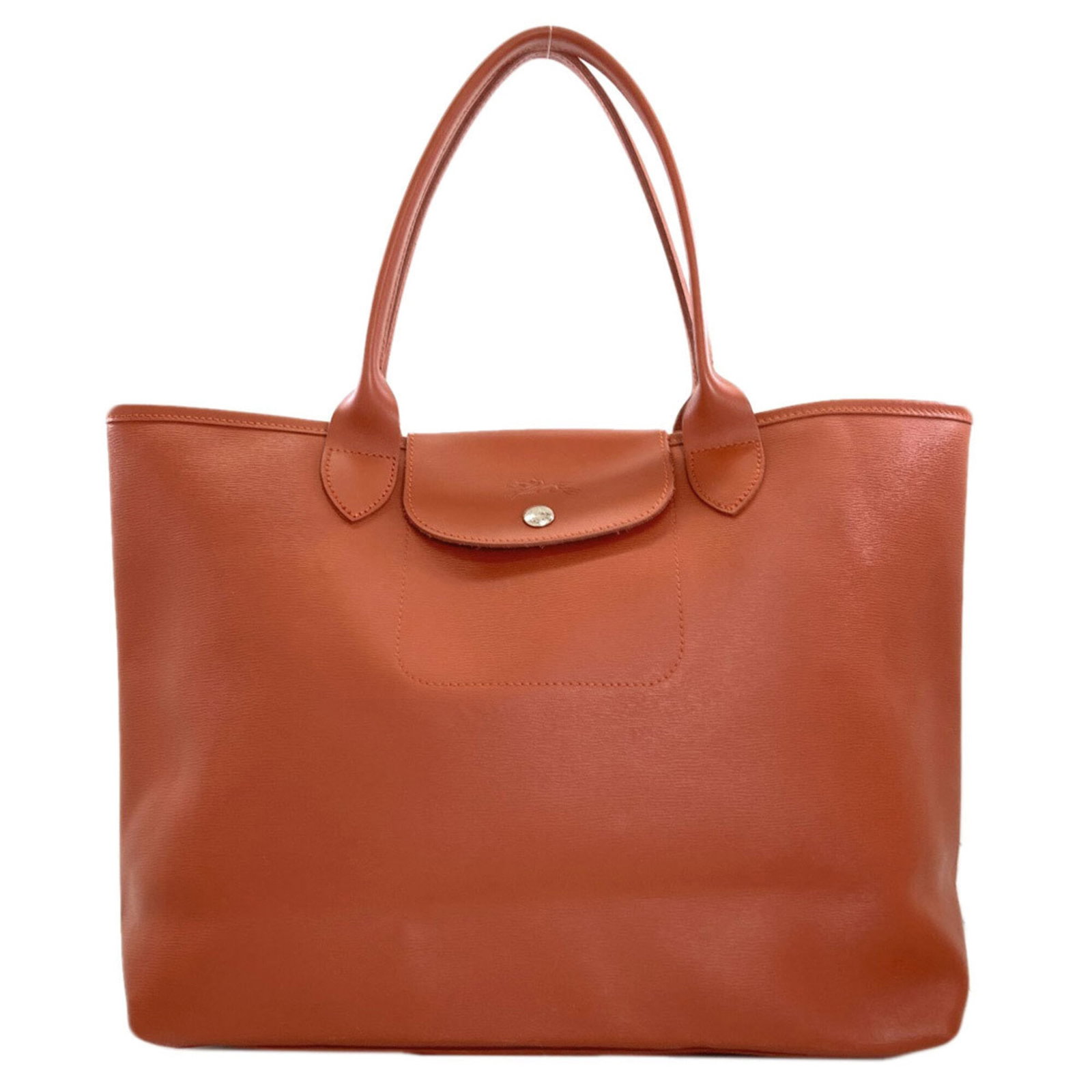 PVC Bag Tote Longchamp: PVC Bag Tote Longchamp The Longchamp Le Pliage Tote Bag in Brown features a durable PVC material, snap fastener closure, and multiple pockets for organization. With its classic design and versatile