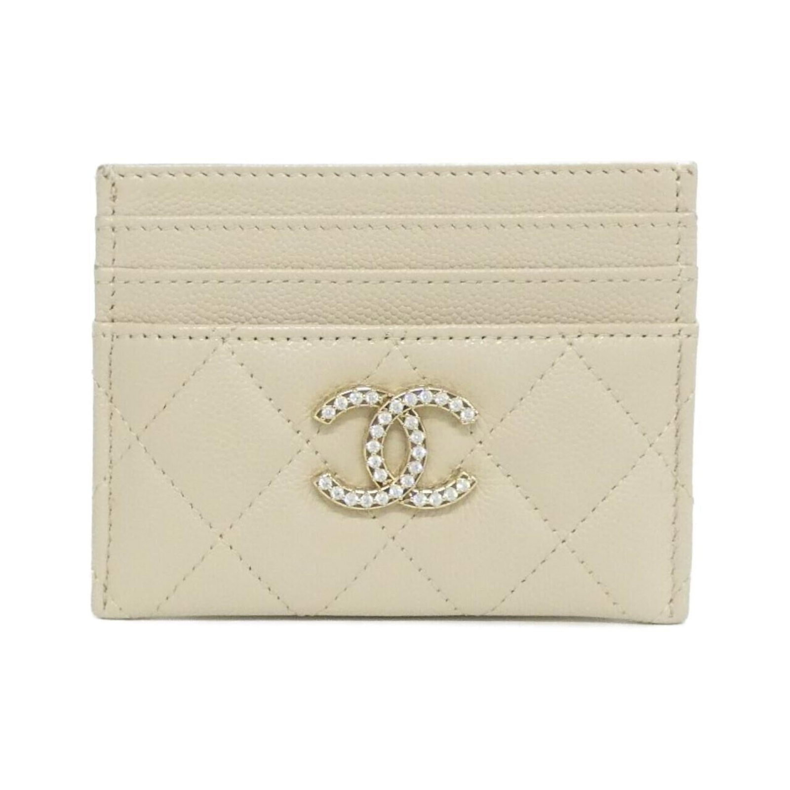 Calfskin card case by Chanel: Calfskin card case by Chanel Calfskin card case by Chanel features a classic design with a subtle beige color and grained texture. Made from high-quality materials, the compact size (8.5cm x 11.5cm) m