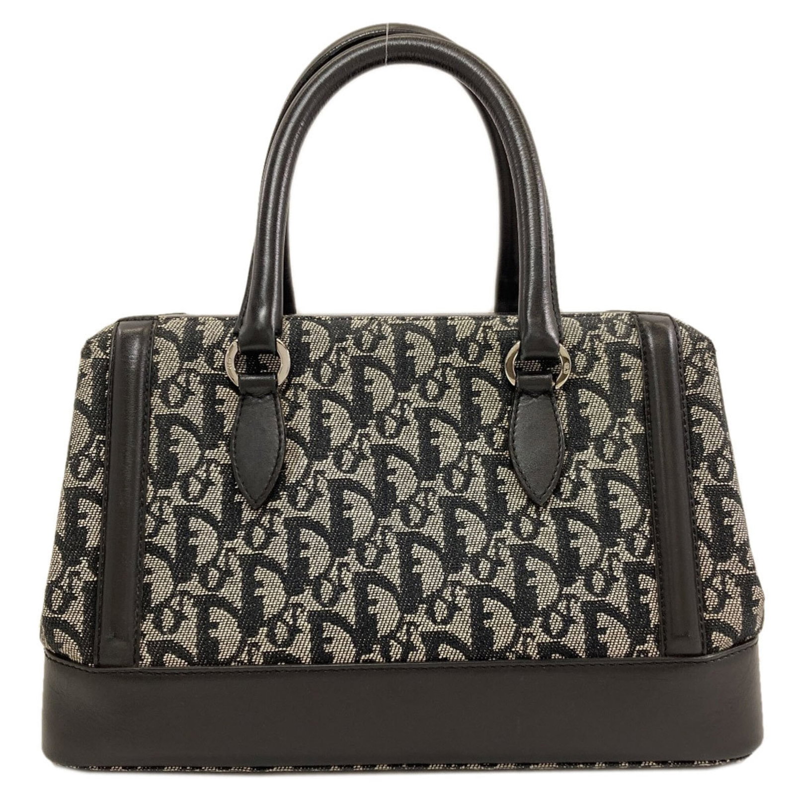 Canvas by Dior Christian: Canvas by Dior Christian Canvas by Dior Christian is a black canvas handbag with dimensions of 19cm x 26.5cm x 14.5cm, making it a stylish and compact accessory for everyday use. The bag's canvas