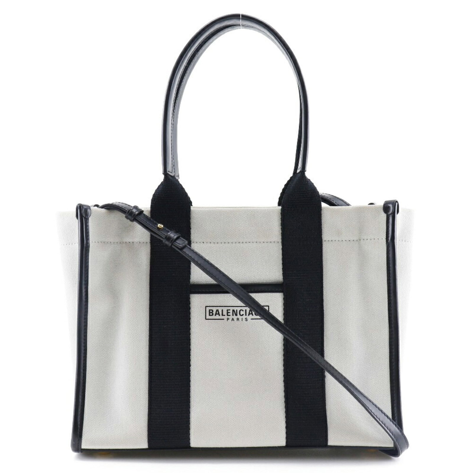 Canvas tote bag by Balenciaga: Canvas tote bag by Balenciaga Canvas tote bag by Balenciaga, featuring a sleek black and white design. This canvas tote bag comes with dust bag, pouch, and shoulder strap for added convenience.