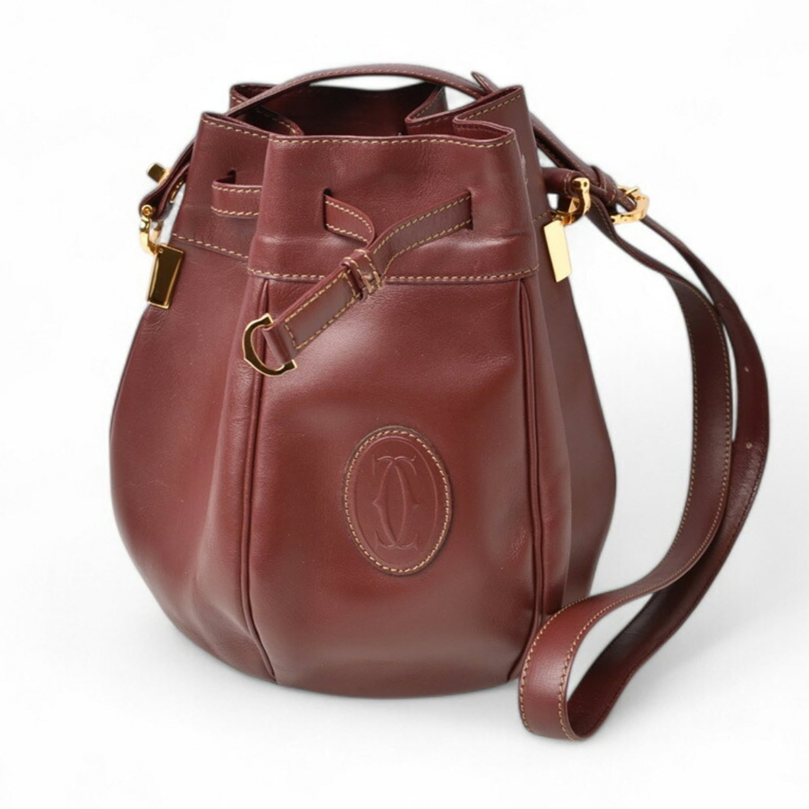 Shoulder Bag Leather by Cartier: Shoulder Bag Leather by Cartier Cartier's Bordeaux leather shoulder bag boasts a classic design with clean lines and a timeless aesthetic. Made from high-quality leather, its 19cm x 23cm x 17cm dimens