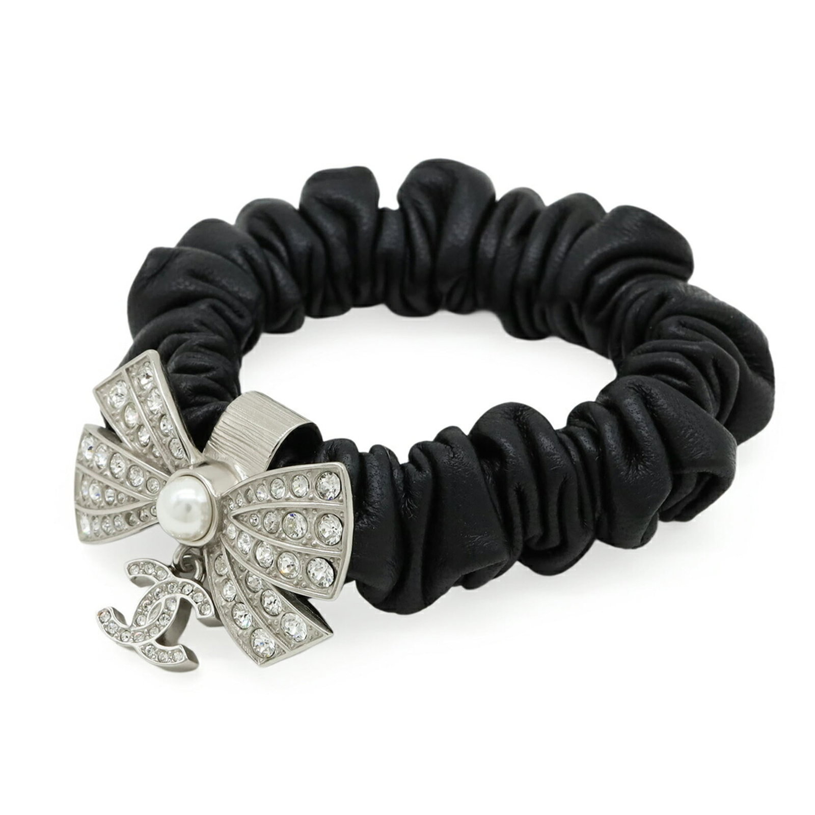 Artificial pearl leather rhinestone scrunchie by Chanel: Artificial pearl leather rhinestone scrunchie by Chanel Artificial pearl, leather, and rhinestone details come together in this unique scrunchie from Chanel. The black and silver color combination