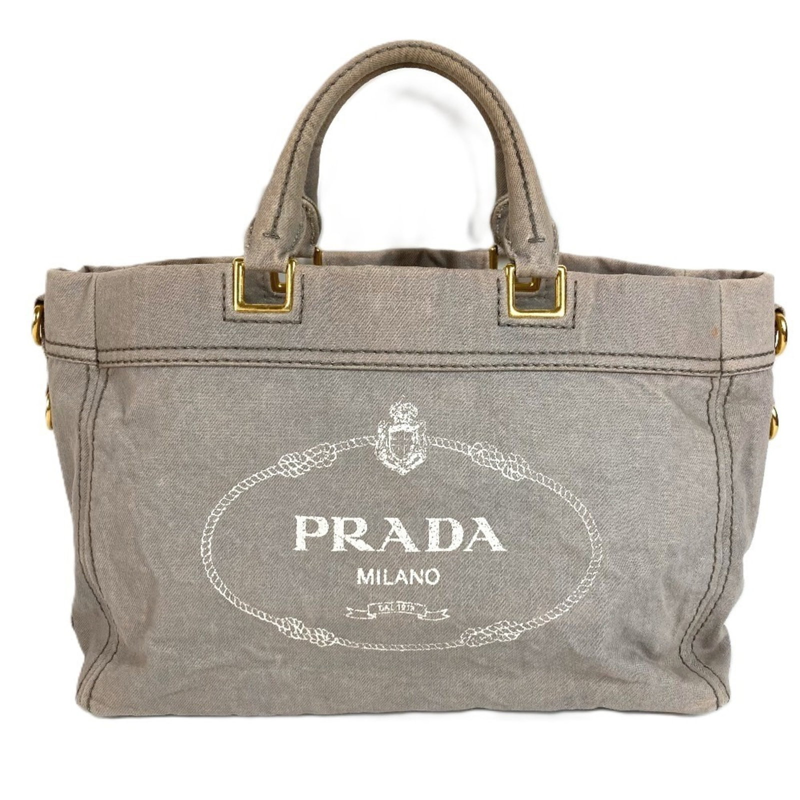 Canvas bag tote handbag by Prada: Canvas bag tote handbag by Prada Canvas bag tote handbag by Prada, crafted from high-quality canvas in a versatile gray hue. Measuring 25cm x 37.5cm x 14cm, this stylish tote features a classic design