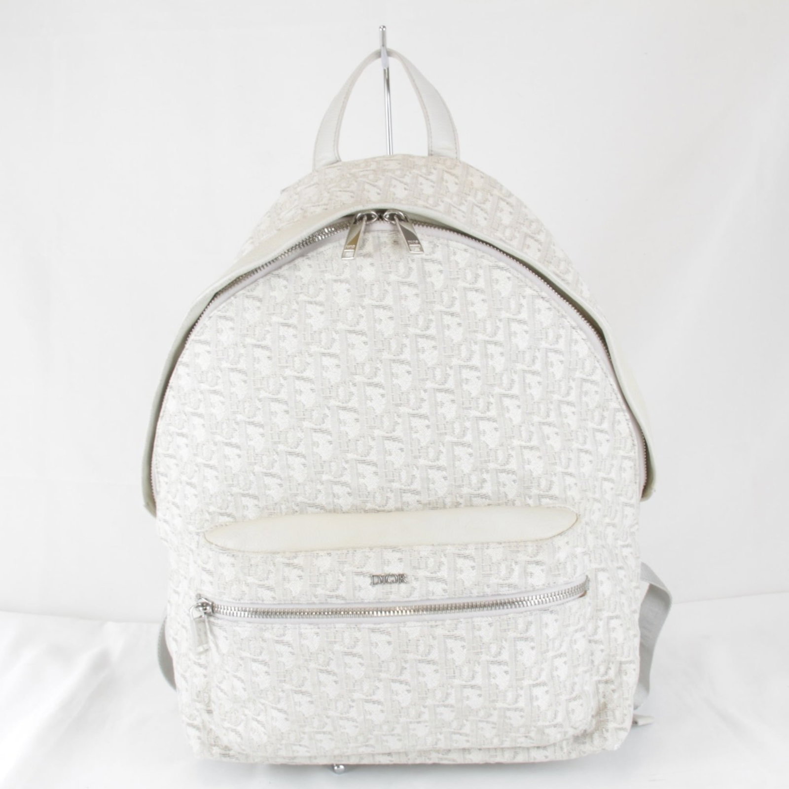 Christian Dior Canvas Leather Backpack: Christian Dior Canvas Leather Backpack Canvas and leather backpack from Christian Dior, featuring a white color and dimensions of 36cm x 35cm x 12cm. This stylish women's backpack combines canvas and 