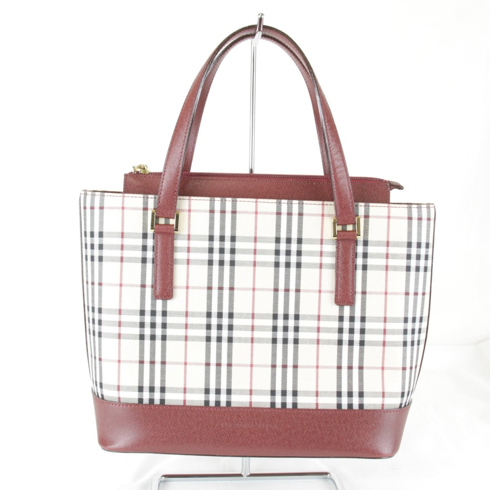 Burberry Handbag Leather Canvas: Burberry Handbag Leather Canvas Canvas and leather combine in this vibrant red Burberry handbag, crafted with a 20cm x 24cm x 11cm size. The bag's canvas material provides a unique texture, while the