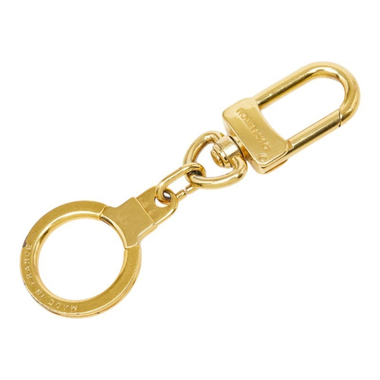 Louis Vuitton Keyring Gold Plating: Louis Vuitton Keyring Gold Plating Gold plating adds a touch of luxury to this Louis Vuitton keyring, making it a stylish accessory for everyday use. The item bears the signature of the brand, a testa