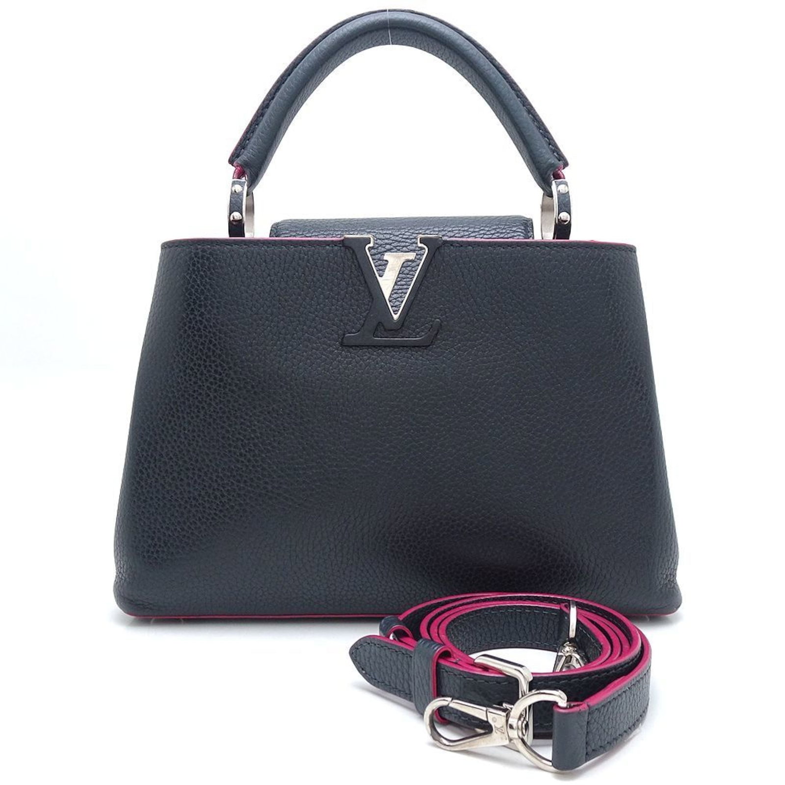 Louis Vuitton Handbag Leather: Louis Vuitton Handbag Leather Taurillon leather adds a touch of sophistication to this Louis Vuitton handbag, featuring the iconic cobalt and fuchsia color combination. The bag's compact size and