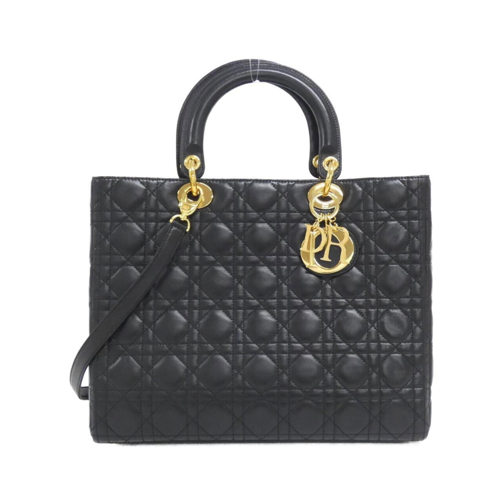 Handbag Christian Dior Leather: Handbag Christian Dior Leather Christian Dior's iconic handbag is crafted from luxurious lamb leather, boasting a sleek black finish. Measuring 24cm x 32cm x 12cm, this stylish accessory is designed t