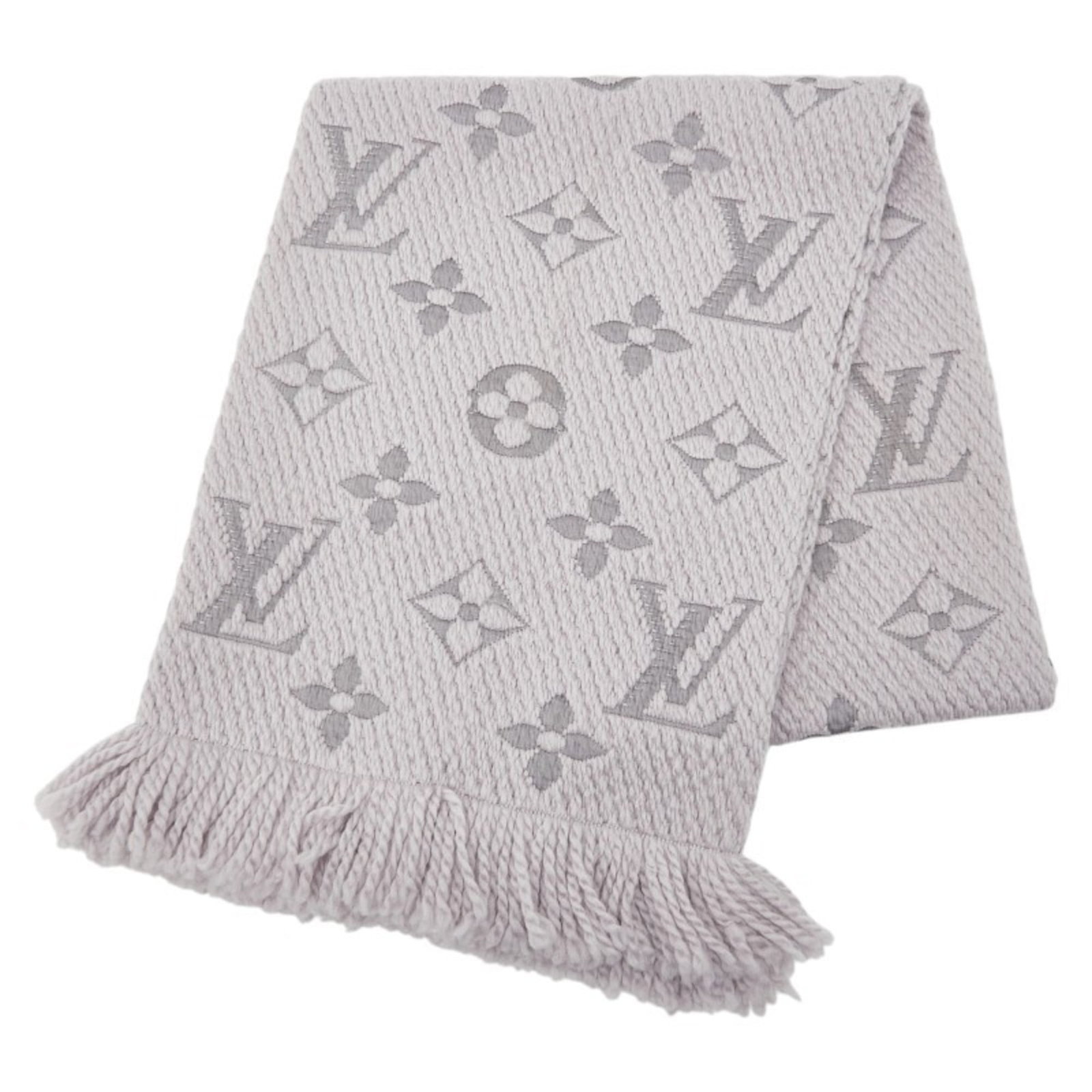 Silk stole by Louis Vuitton: Silk stole by Louis Vuitton Silk stole by Louis Vuitton, featuring a striking gray color and elegant dimensions of 1.64m x 29cm. Made from a luxurious blend of wool and silk, this stole showcases the 