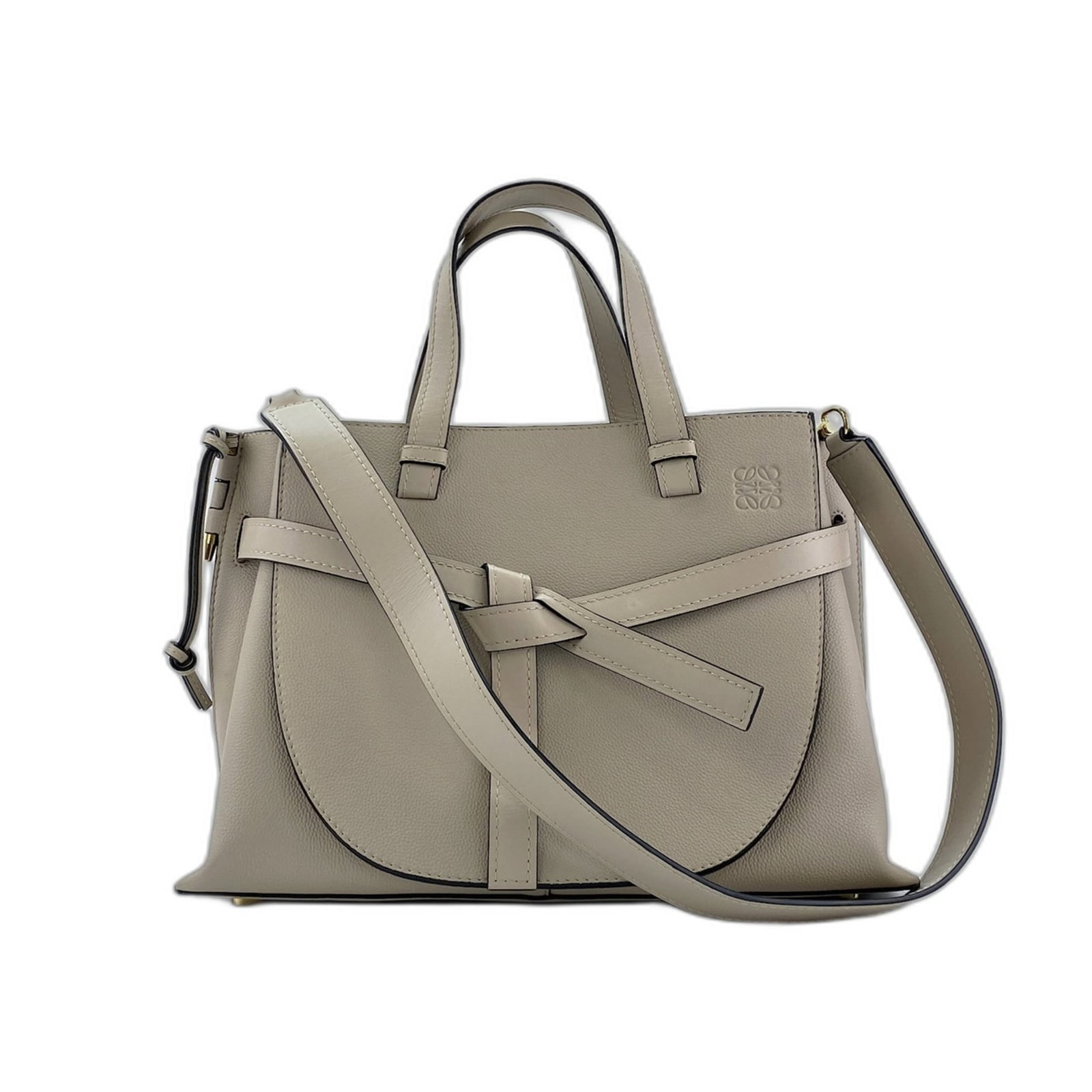 Handbag by Loewe: Handbag by Loewe Loewe's iconic handbag boasts a sleek, beige hue and refined dimensions, measuring 27cm x 37cm x 14cm. The bag's Country of Origin is Spain, where craftsmanship and design expertise