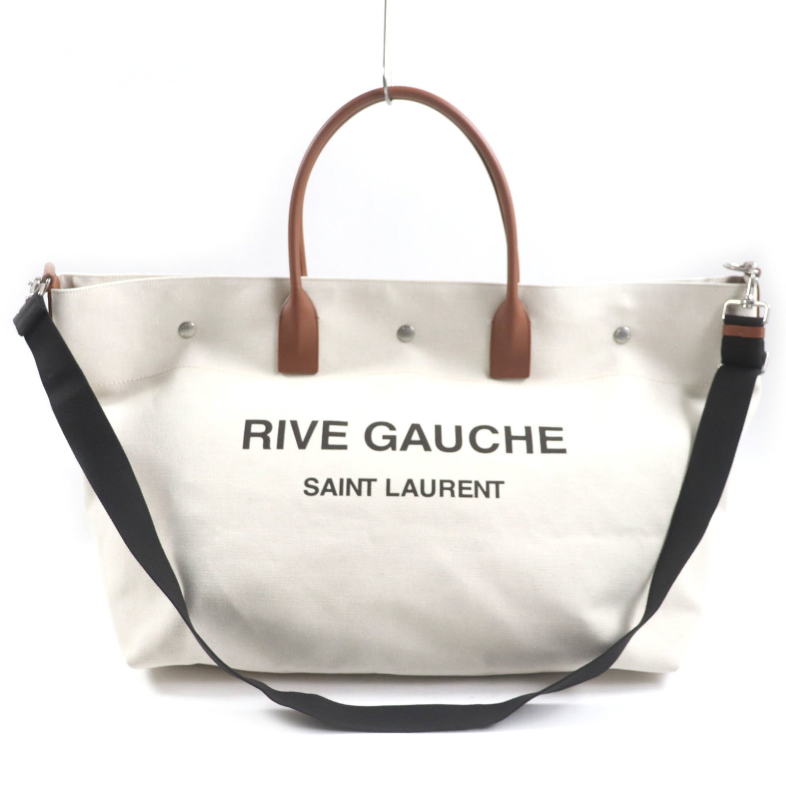 Saint Laurent Shopping Bag Tote Bag Canvas Leather: Saint Laurent Shopping Bag Tote Bag Canvas Leather Canvas and leather blend in beige and brown tones, defining the Saint Laurent Shopping Bag Tote Bag. A zipper pocket adds convenience, while a snap