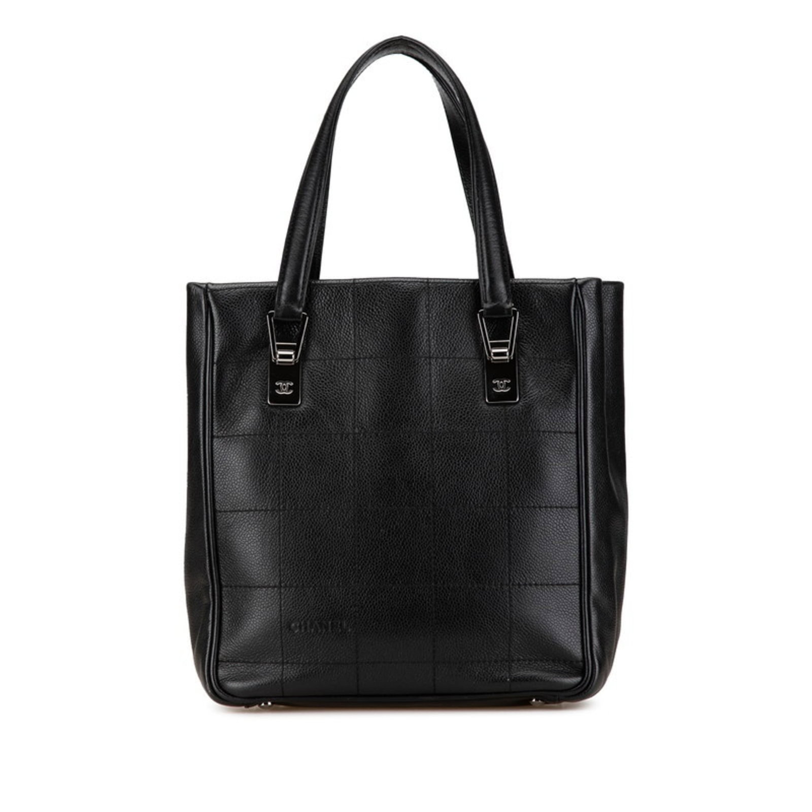 Calfskin bag tote by Chanel: Calfskin bag tote by Chanel Calfskin bag tote by Chanel, featuring a sleek black design with an open closure and a functional zipper pocket for added convenience. Made from high-quality grained