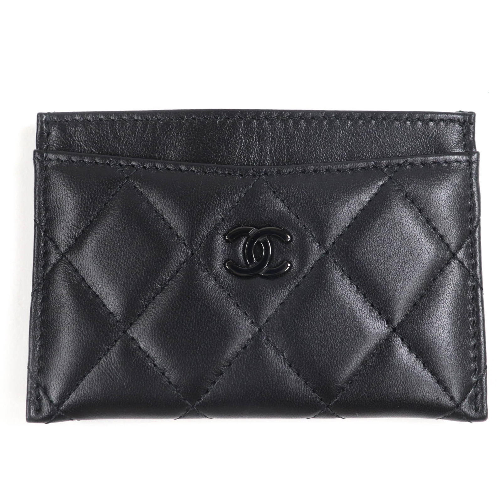 Case leather business card Chanel: Case leather business card Chanel This luxurious leather business card case from Chanel features a sleek black lambskin exterior, adorned with the iconic brand's signature style. The compact design