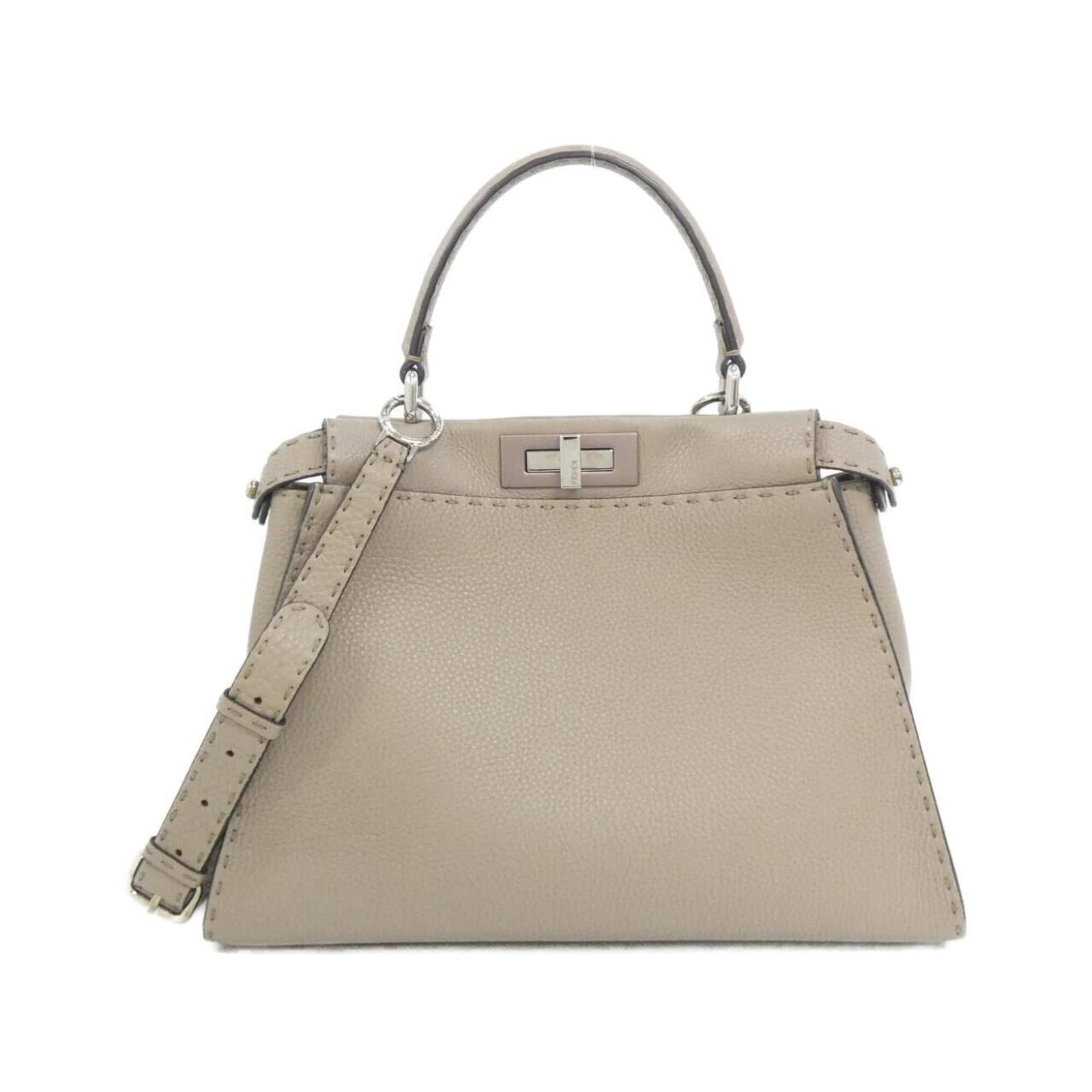 Fendi Handbag Leather: Fendi Handbag Leather Calfskin leather construction provides durability and sophistication to this elegant beige Fendi handbag. Measuring 24cm x 34cm x 12cm, the bag's classic design and sleek silver 