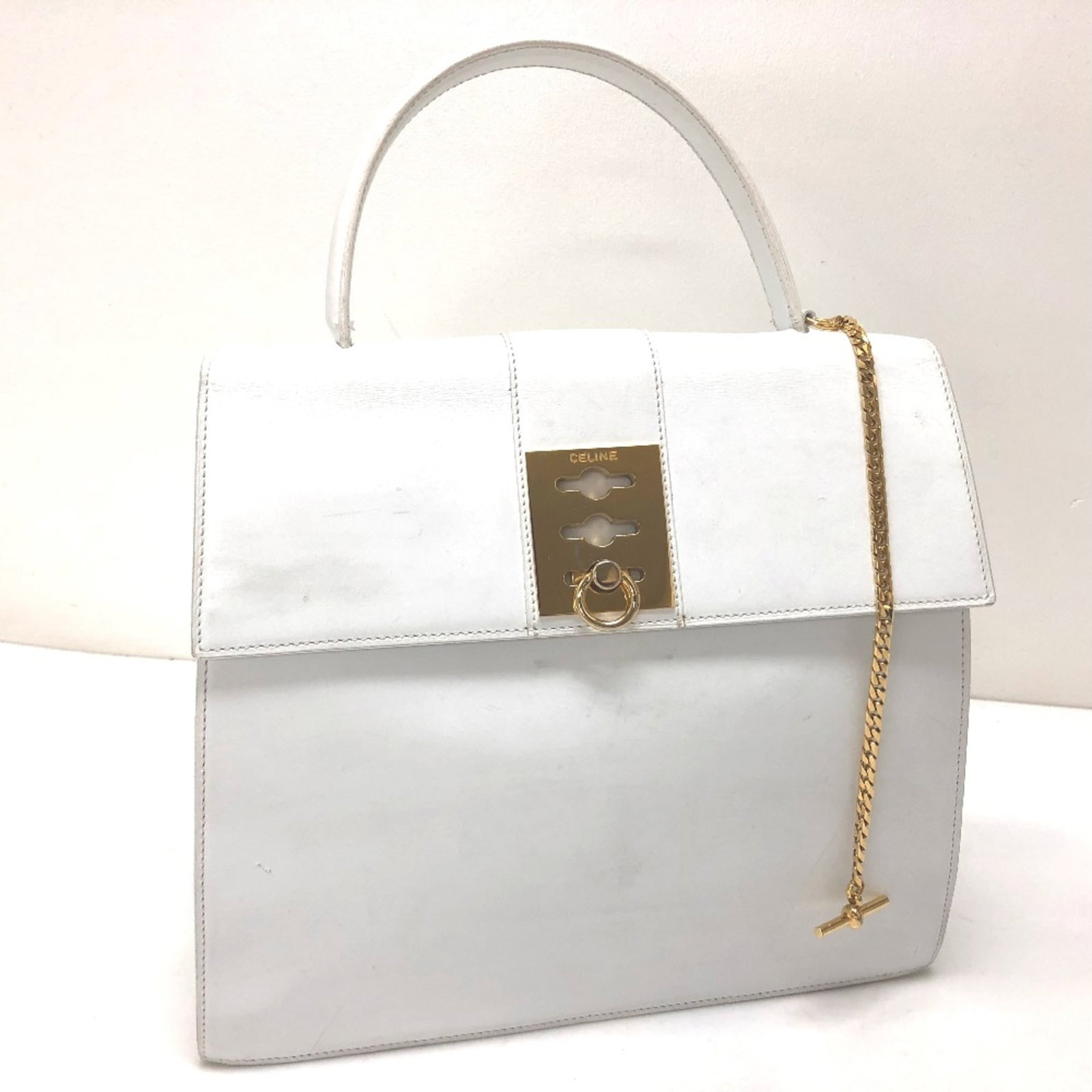 Handbag Celine Leather: Handbag Celine Leather White Celine Leather Handbag. Measuring 23.5cm x27.5cm x9cm, this handbag features high-quality leather construction and a classic design. Its compact size makes it a versatile