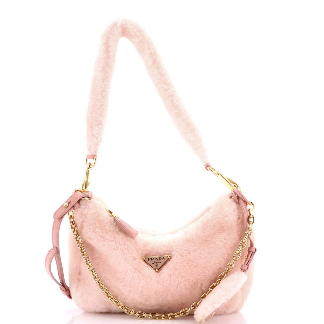 Shearling mini shoulder bag re-edition by Prada: Shearling mini shoulder bag re-edition by Prada Shearling mini shoulder bag re-edition by Prada boasts a striking pink exterior made from luxurious shearling, complemented by gold hardware and chain s