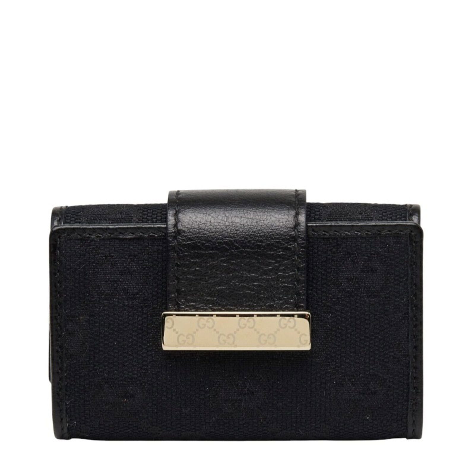 Gucci Keycase Canvas Leather: Gucci Keycase Canvas Leather Canvas and leather combine in sleek, black Gucci design. The compact keycase measures 9.5cm x 6cm x 2cm, making it a convenient accessory for daily use. Its classic style 