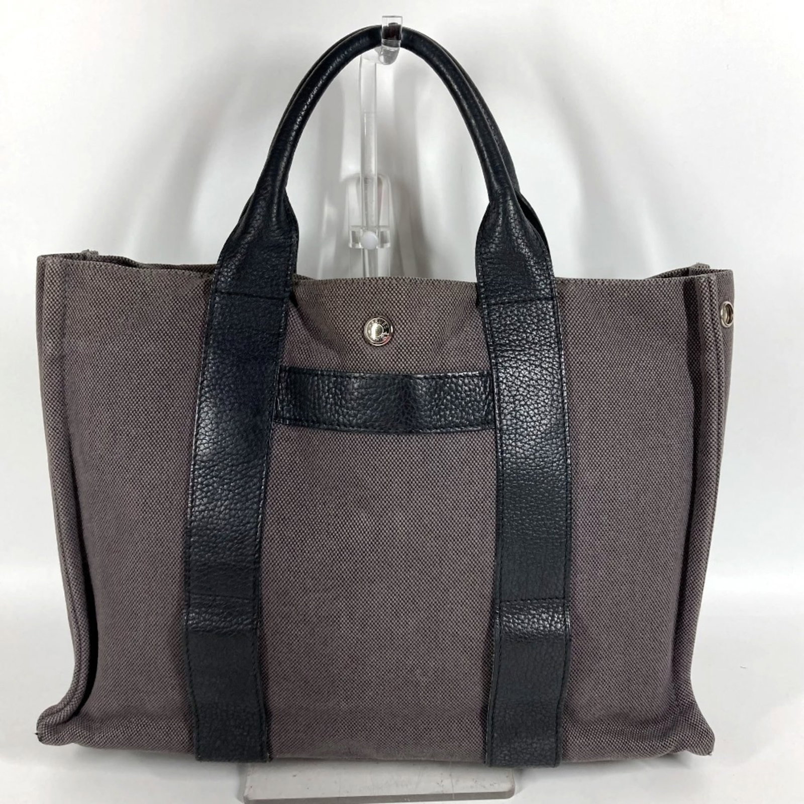 Canvas tote bag leather handbag Hermes: Canvas tote bag leather handbag Hermes Canvas tote bag leather handbag from Hermes, crafted in France with high-quality materials. This black and gray tote measures 27cm x 36.5cm x 9cm and features a