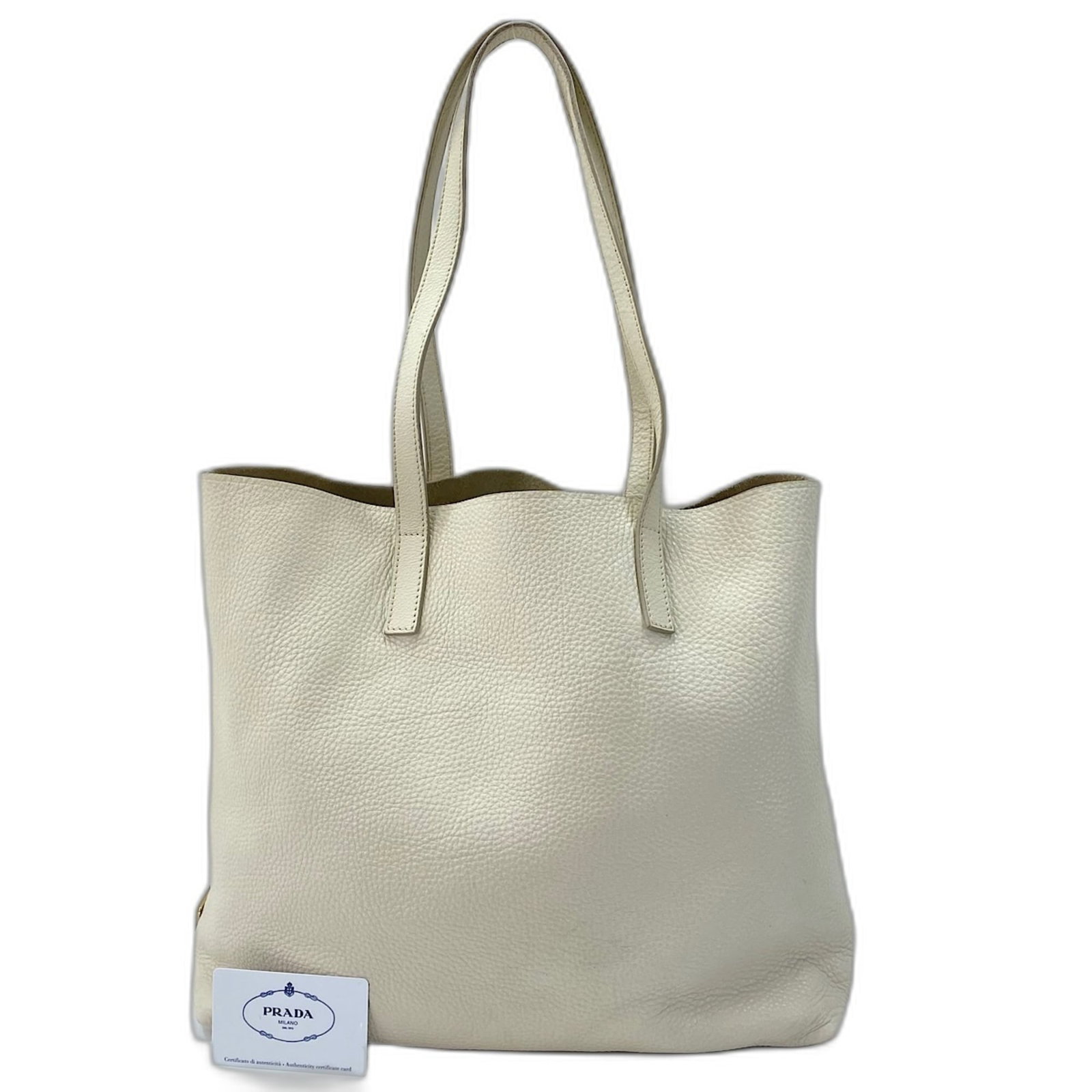 Tote bag leather: Tote bag leather White leather tote bag from Prada, measuring 34cm x 35cm x 13cm. This classic design showcases clean lines and a timeless aesthetic. Made from high-quality leather, the bag's white co