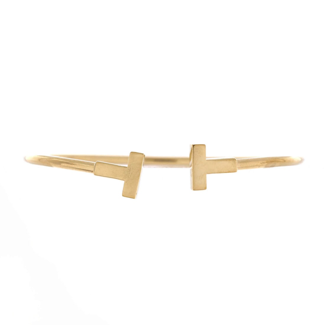Tiffany & Co. T Wire Bracelet 18K Yellow Gold: Tiffany & Co. T Wire Bracelet 18K Yellow Gold Tiffany & Co.'s iconic T Wire Bracelet shines in 18K yellow gold, its classic design timeless and elegant. With a moderate wear patina, this bracelet