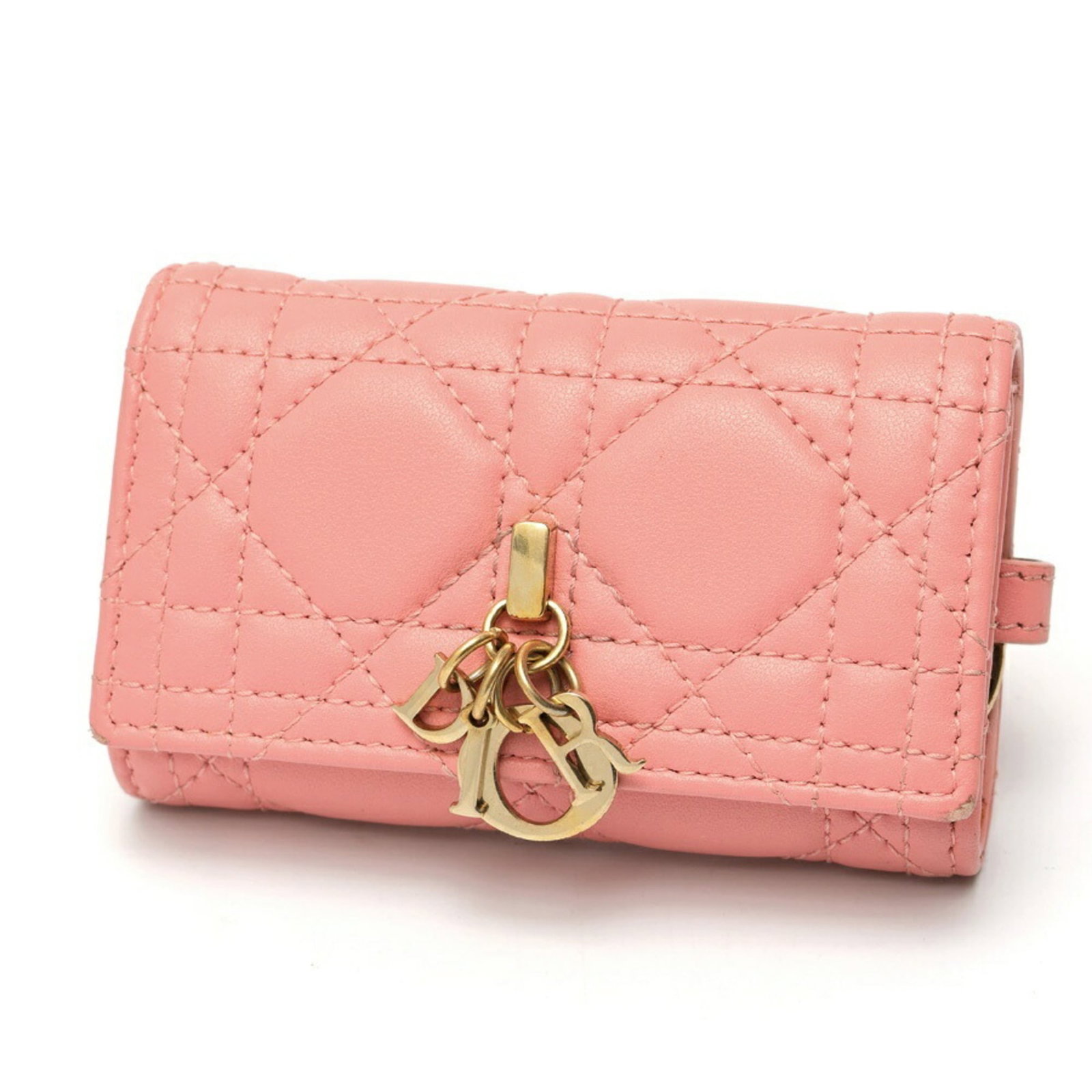 Keycase leather by Christian Dior: Keycase leather by Christian Dior Christian Dior's lambskin keycase boasts a striking pink hue, adding a pop of color to any purse or bag. Made from high-quality leather, this stylish accessory measur