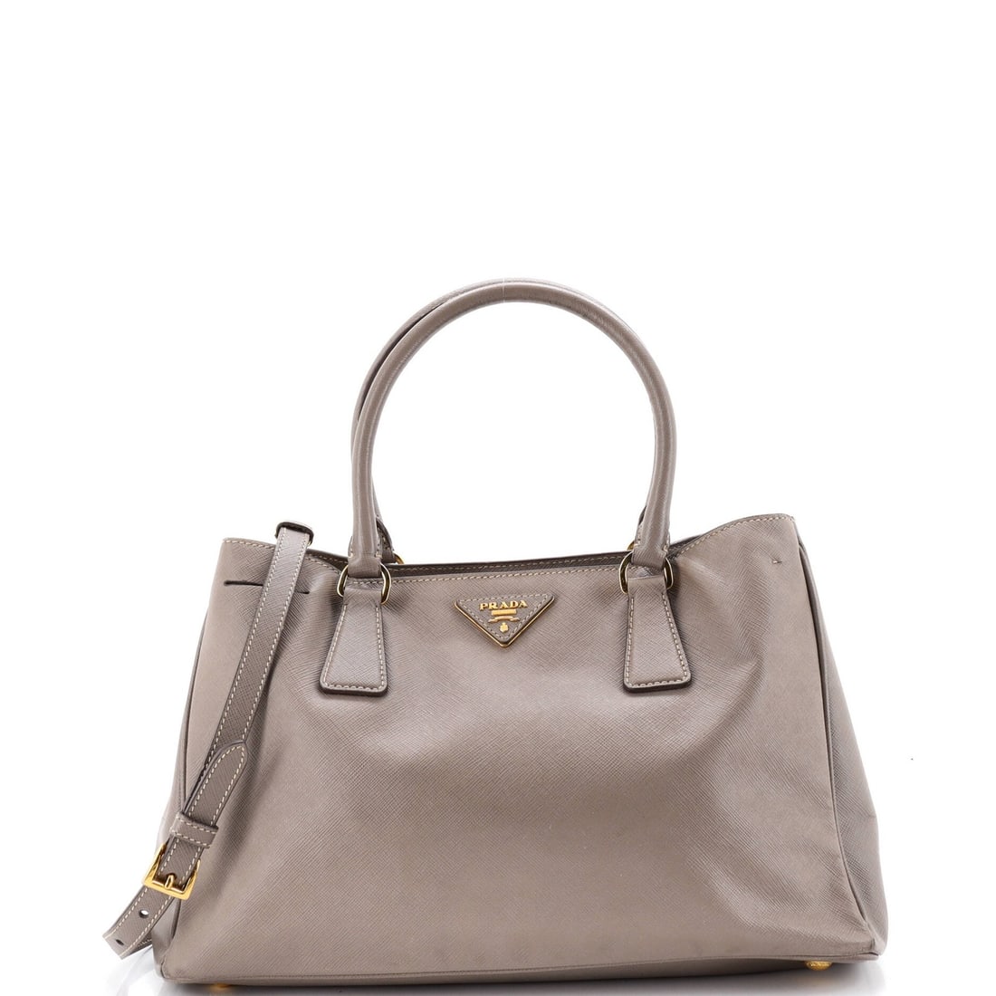 Saffiano Leather Prada Gardener Tote Large: Saffiano Leather Prada Gardener Tote Large Saffiano Leather Prada Gardener Tote Large features a neutral exterior with heavy edge wear, scuffs, stains, and creases. The tote's interior is made of