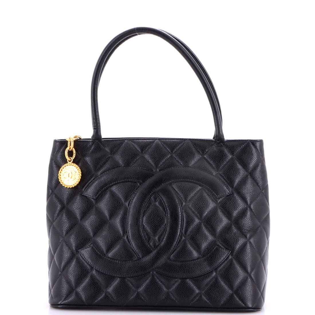 Caviar Quilted Tote Chanel Medallion: Caviar Quilted Tote Chanel Medallion Black quilted caviar leather Chanel medallion tote with gold hardware, featuring scuffs and minor creases on the exterior. The interior boasts black leather and a 